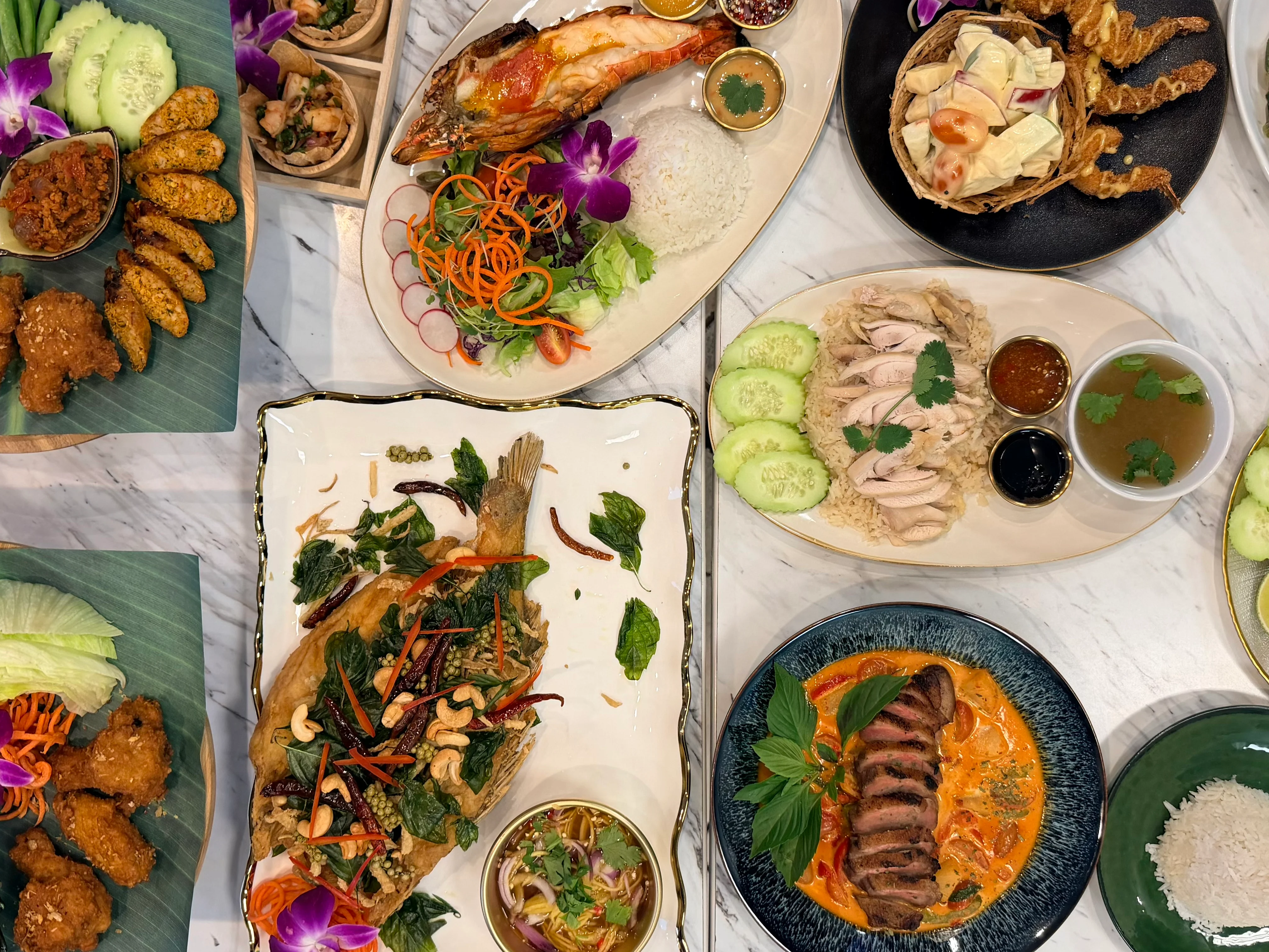 Assorted Thai dishes including fried fish and chicken rice