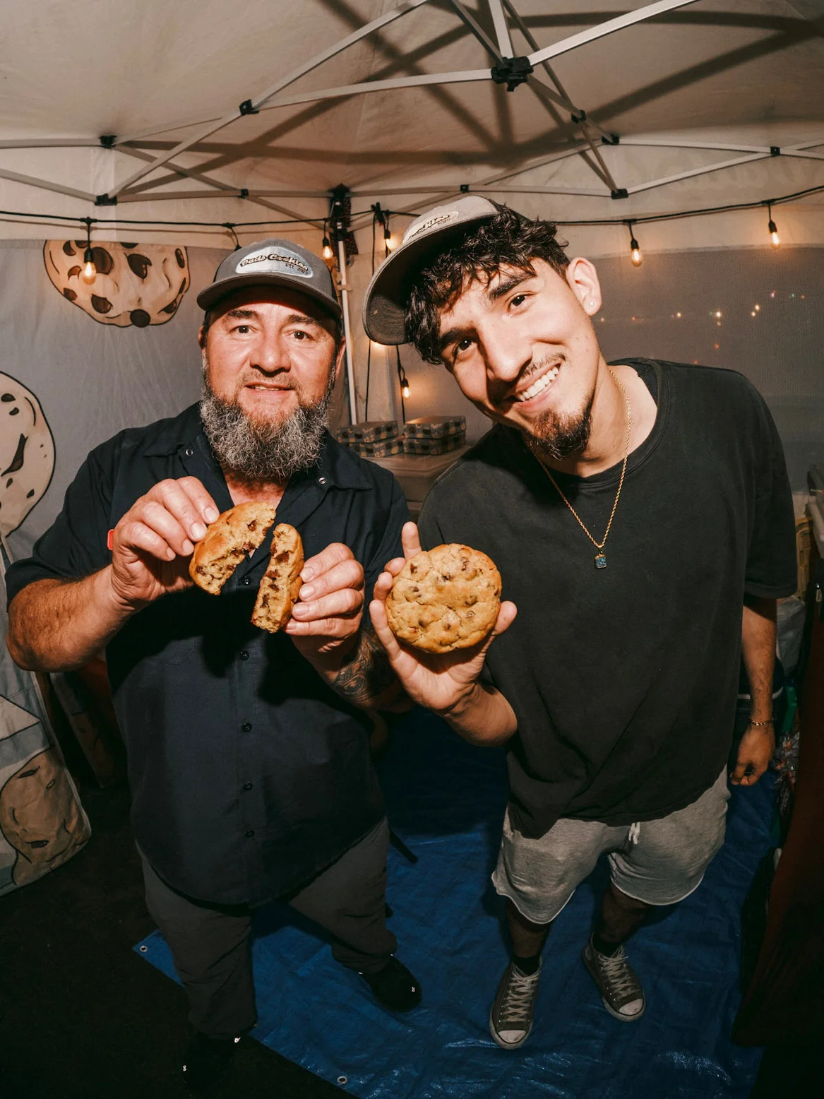 Two smiling staff members at a cookie shop