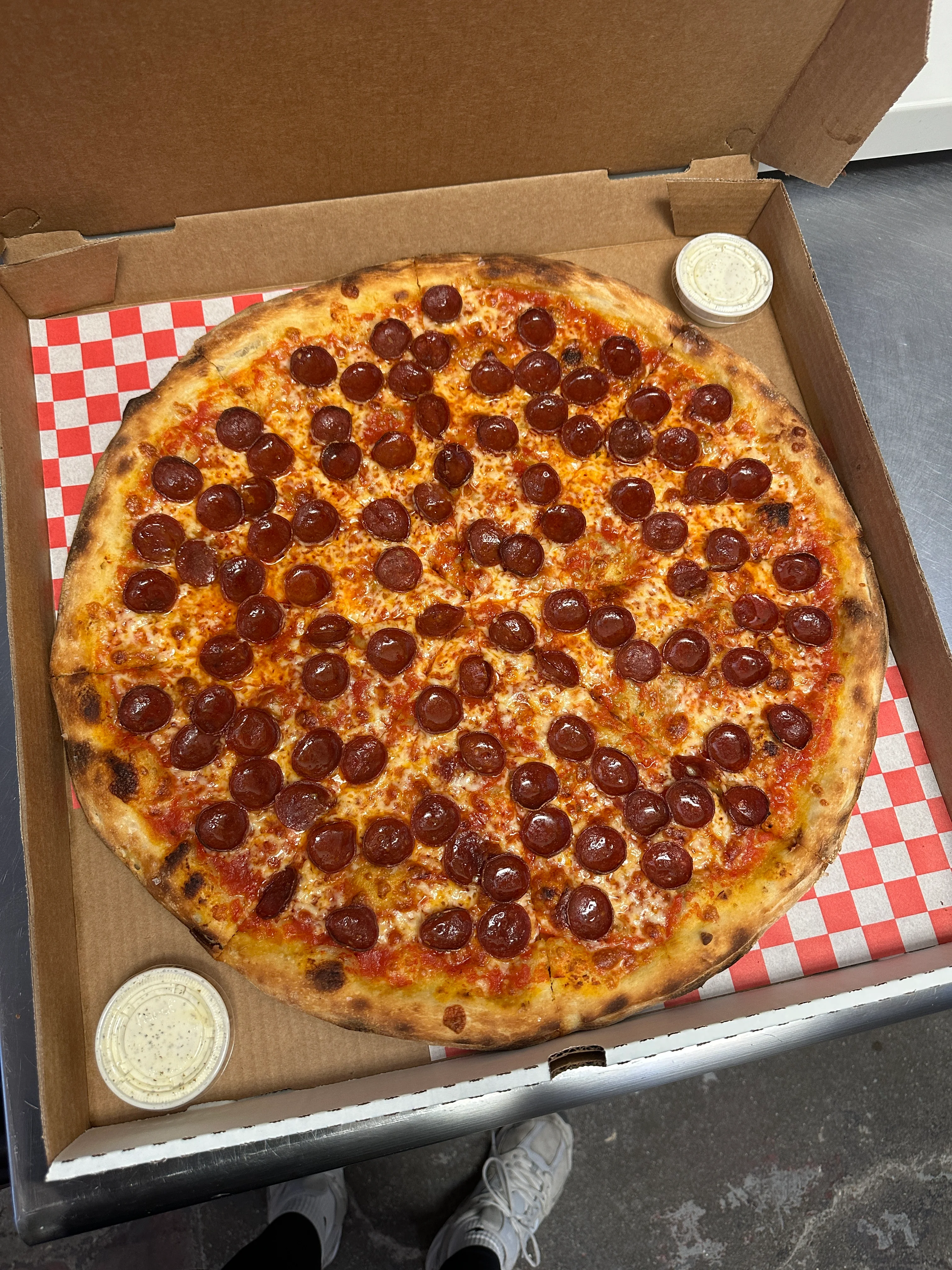Pepperoni pizza in a takeout box