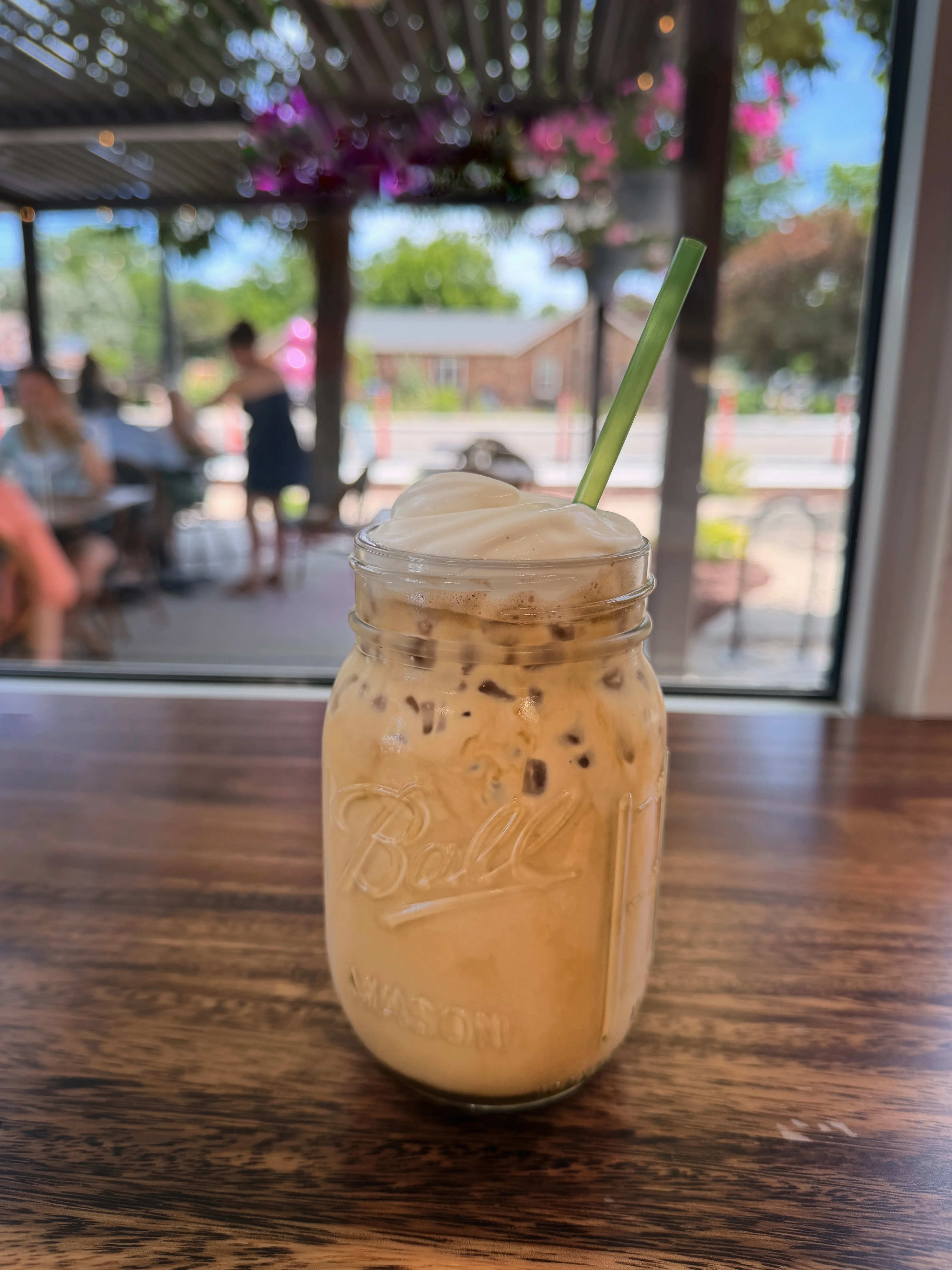 Iced coffee drink in a mason jar with whipped cream