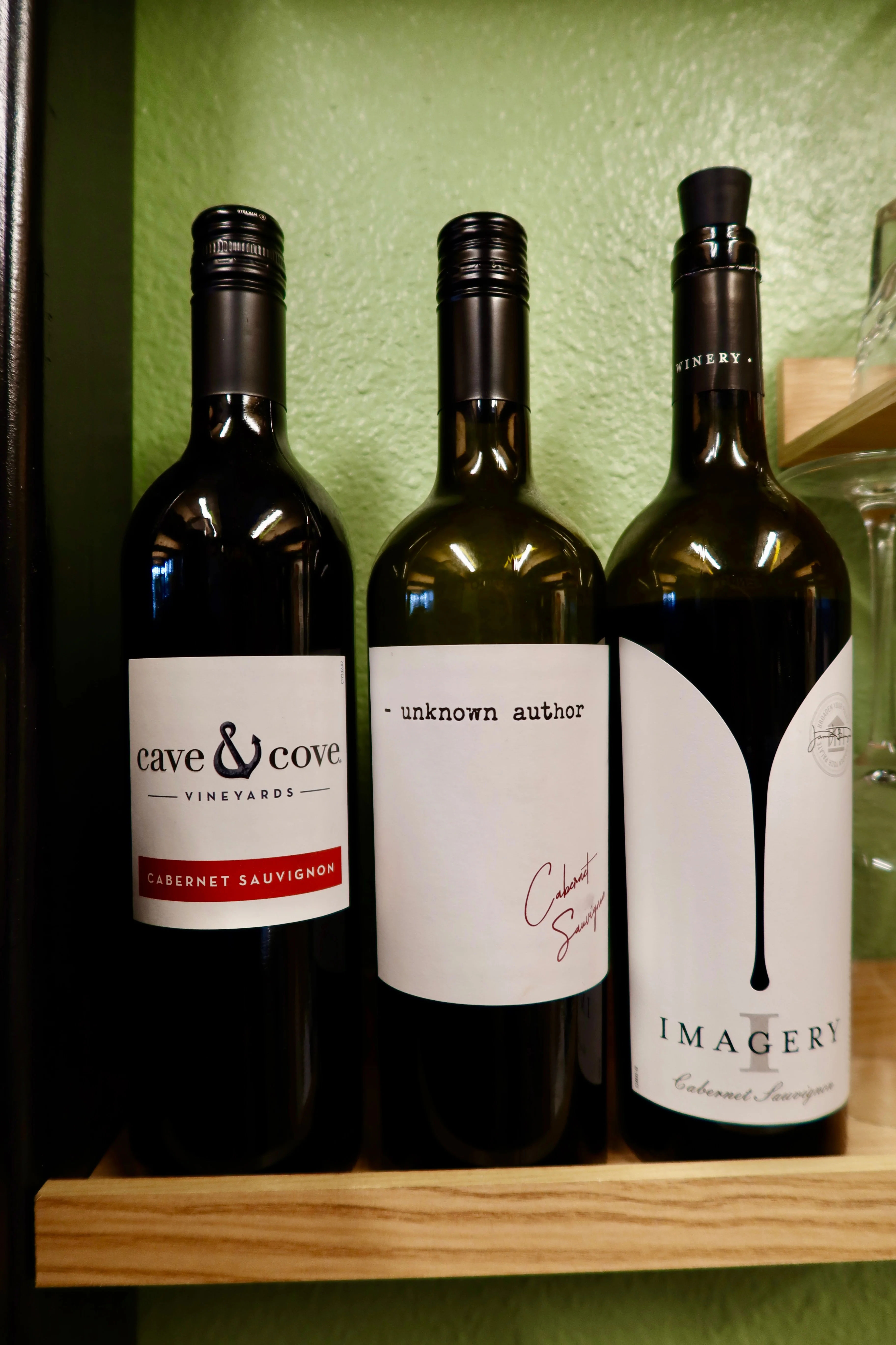 Selection of Cabernet Sauvignon wines on a wooden shelf