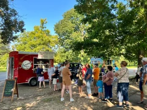 Food truck serving delicious street food in a park setting
