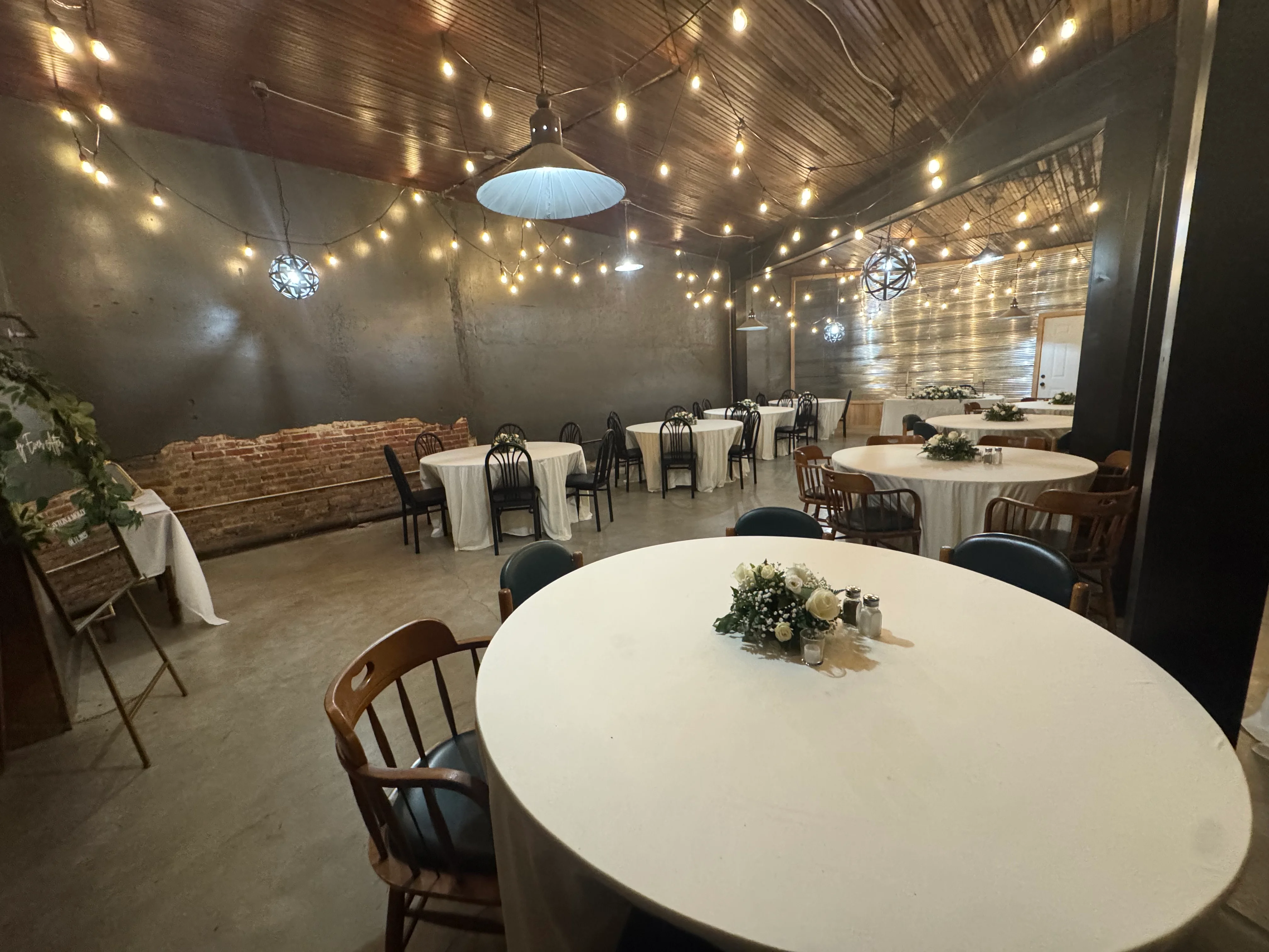 Cozy restaurant interior with round tables and warm string lights