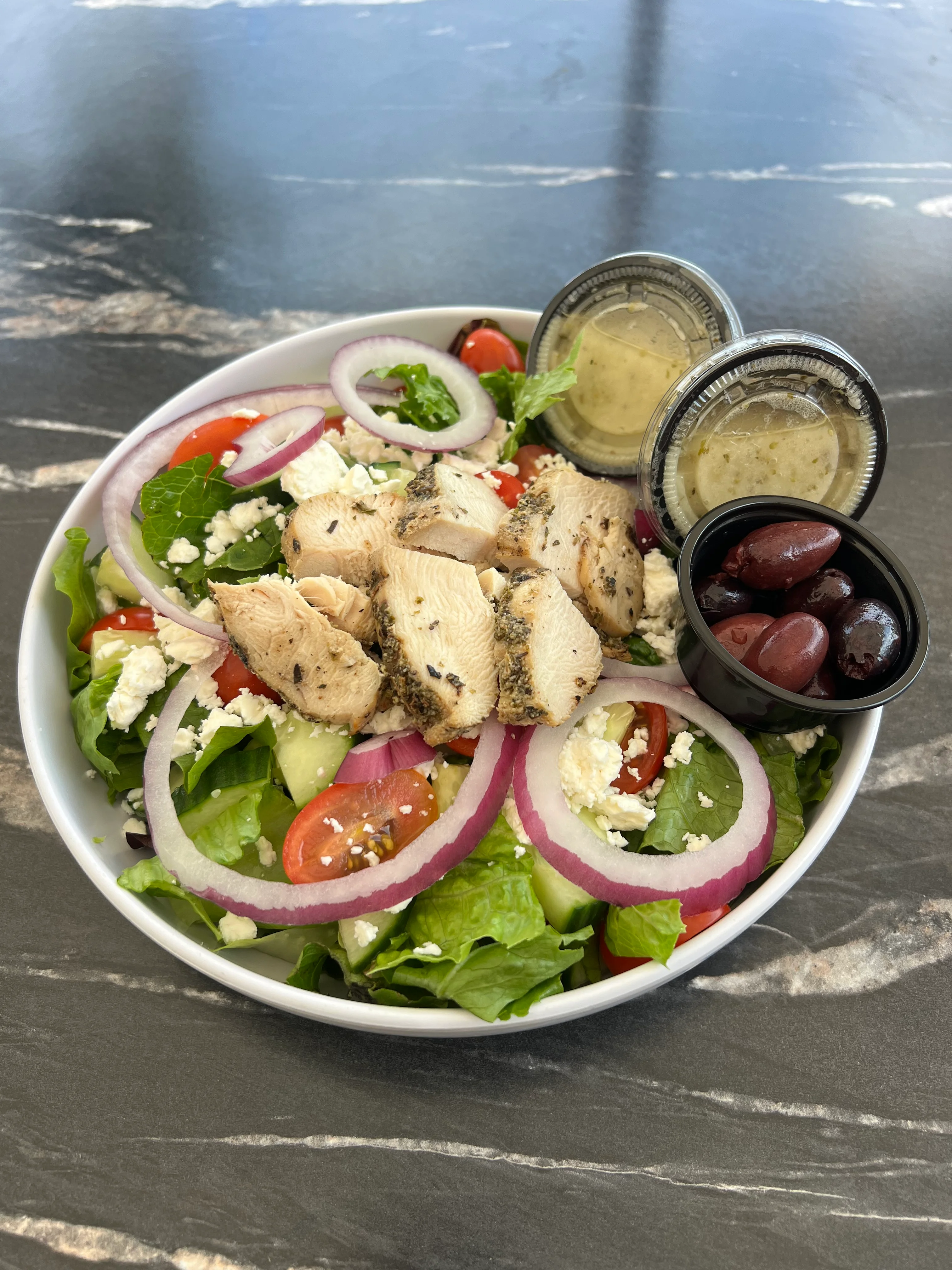 Grilled chicken Greek salad with feta and olives