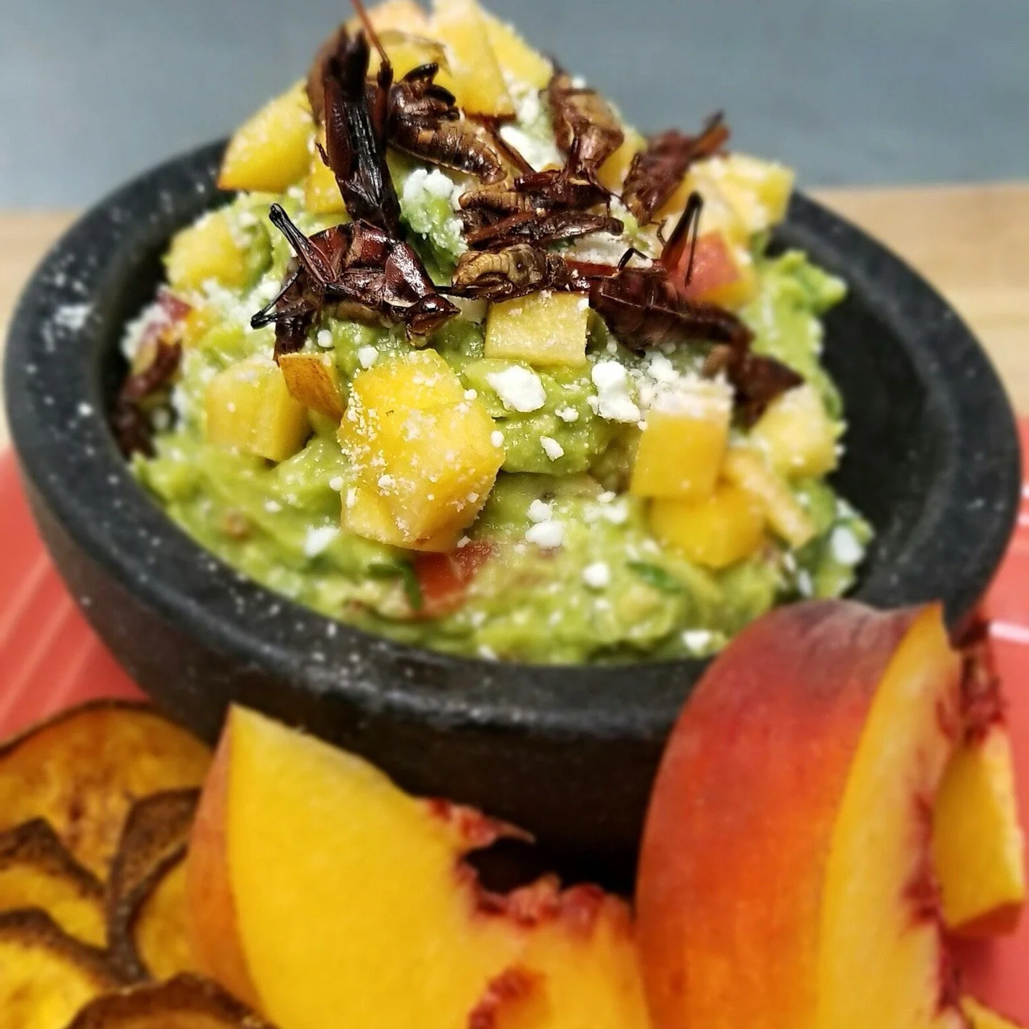 Aztec on Broadway Mexican Restaurant Portland - Guacamole with peaches and chapulines in molcajete