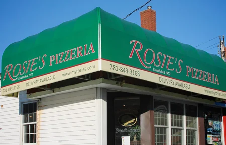 Exterior view of Rosie's Pizzeria with green awning