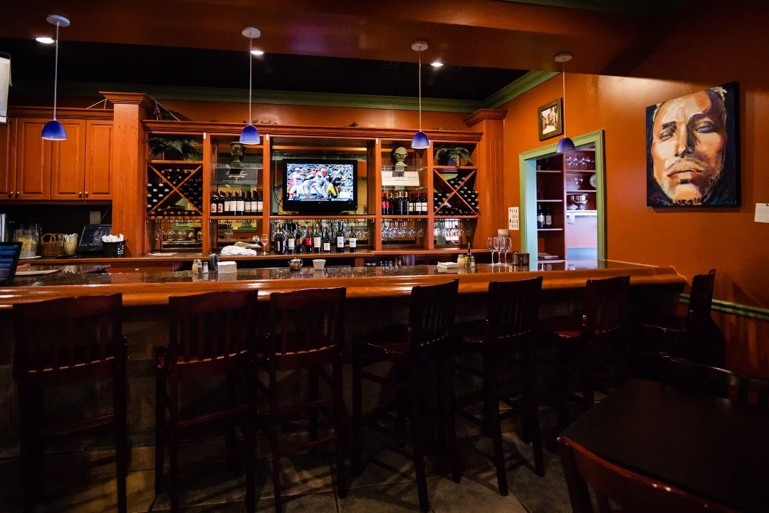 Cozy bar interior with wooden counter and wine display