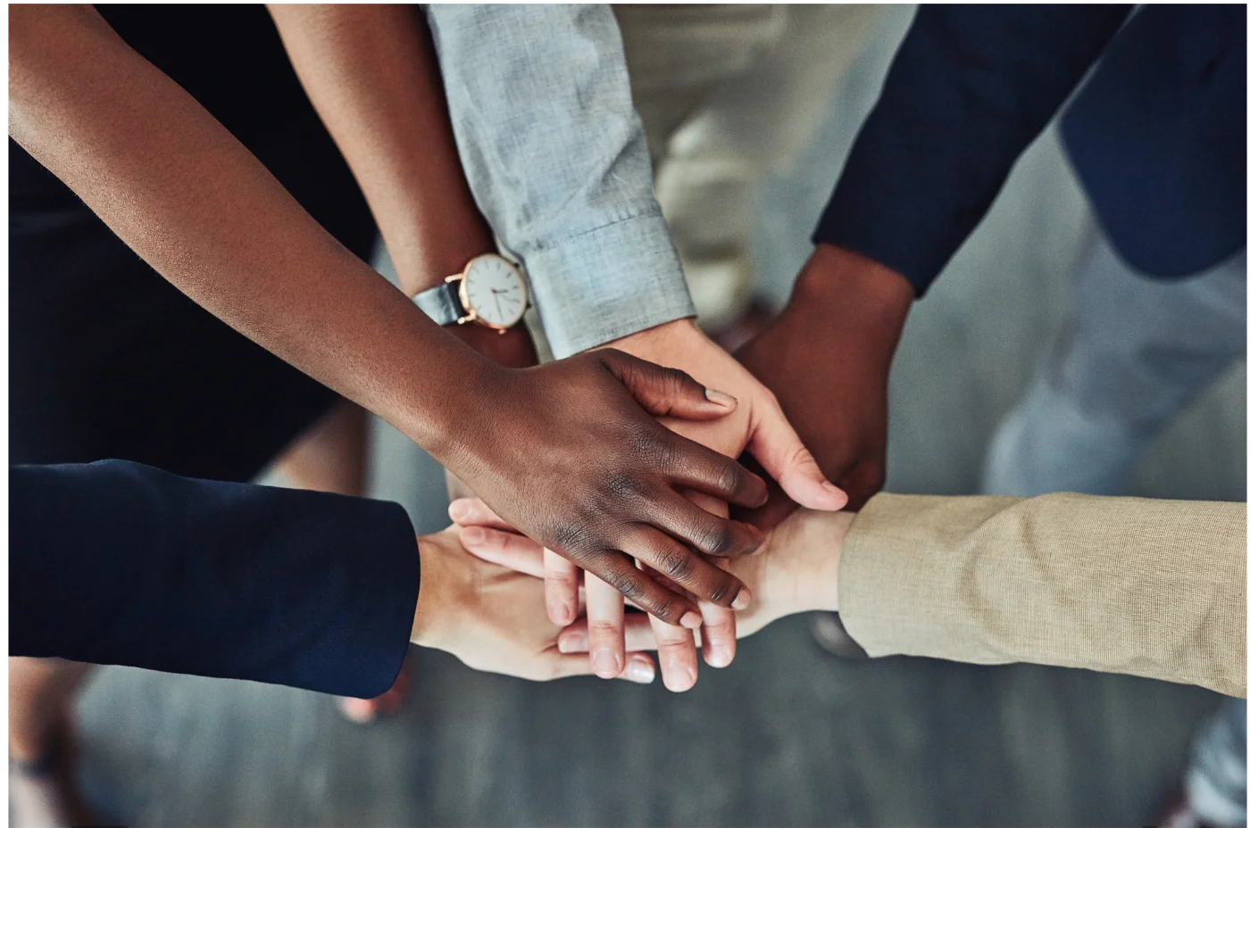 Diverse hands joining together in unity and collaboration