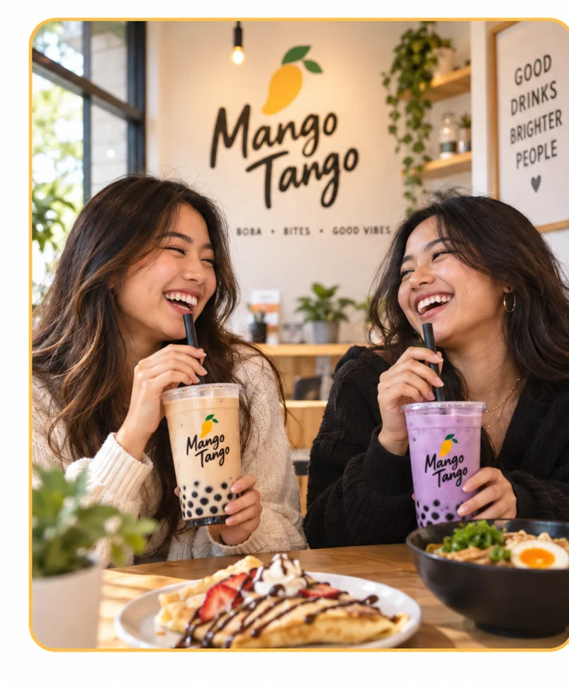 Two friends enjoying boba tea in a cozy cafe setting