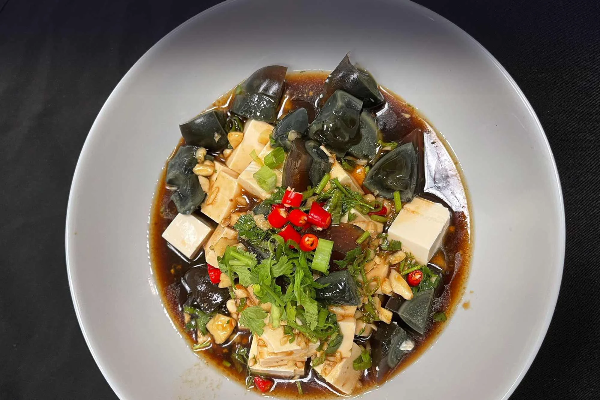 Chinese century egg tofu salad with spicy sauce