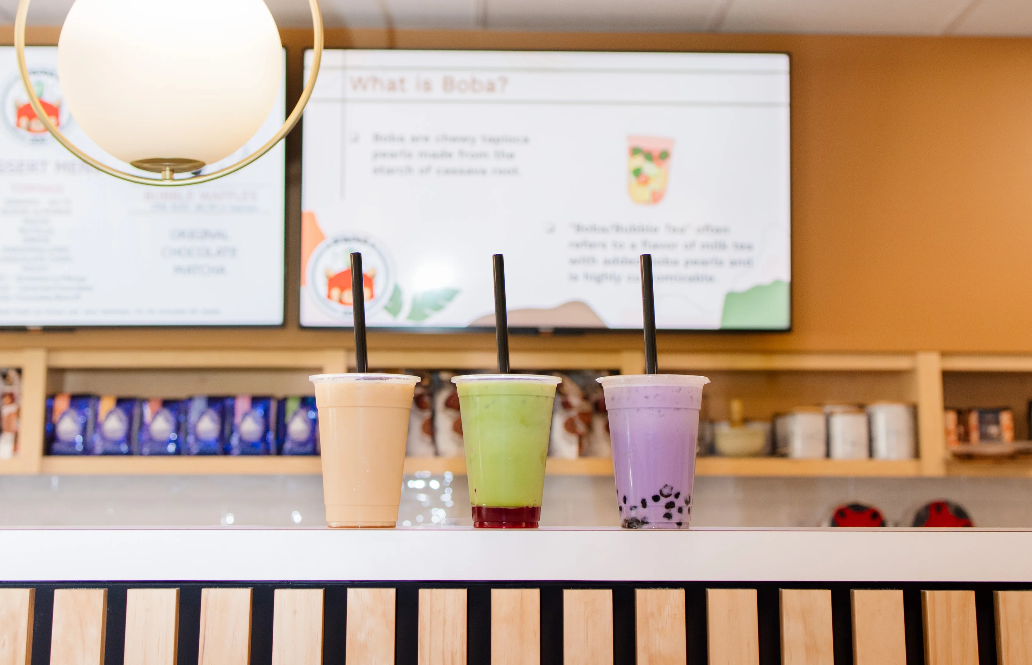 Colorful boba tea drinks in a modern cafe setting