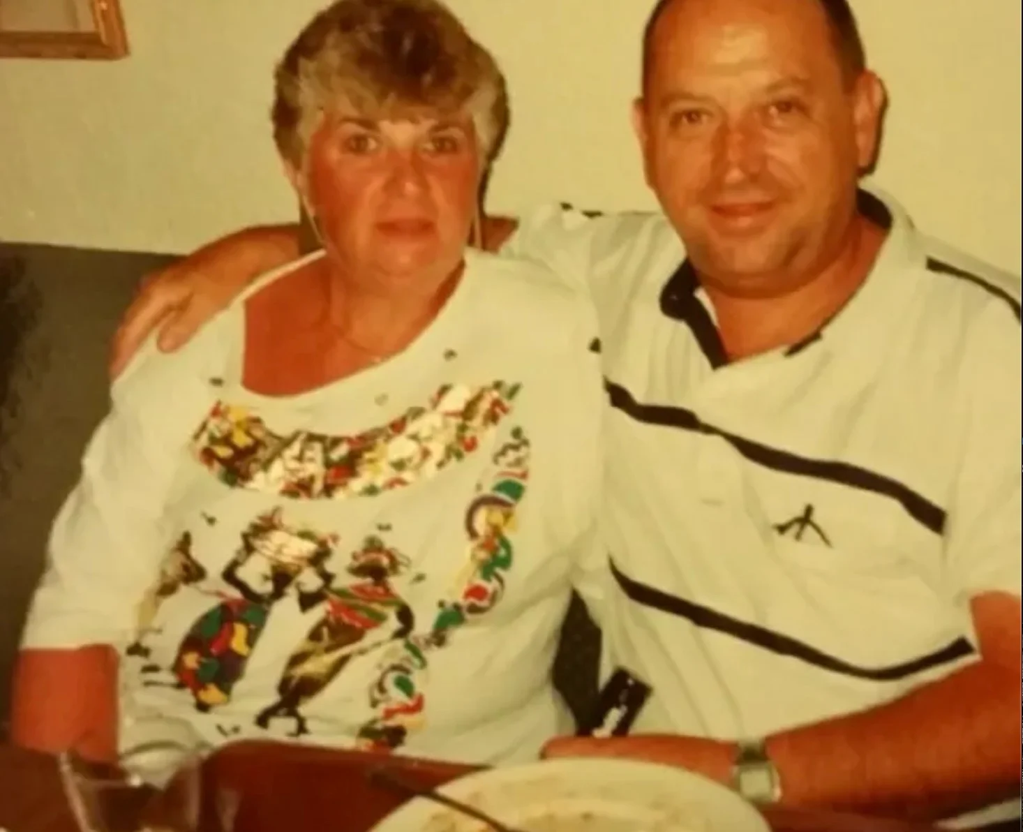 Couple posing together in a cozy restaurant setting.