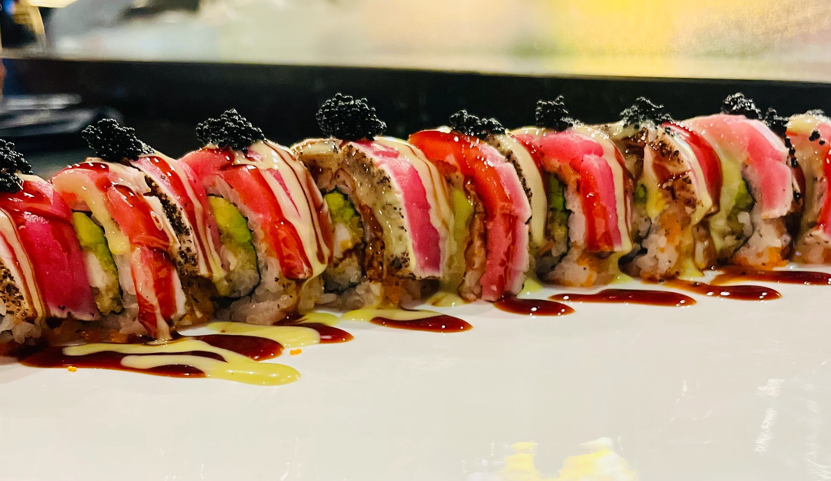 Colorful sushi rolls with fresh fish and sauces