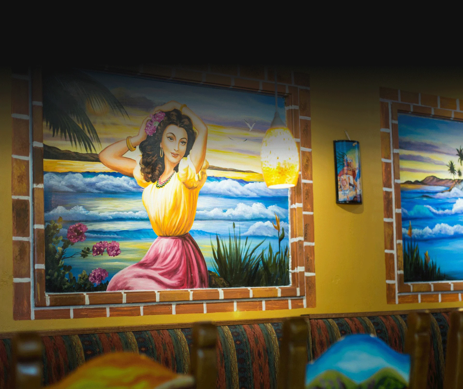 Decorative yellow restaurant wall with a paint of a lady on the beach
