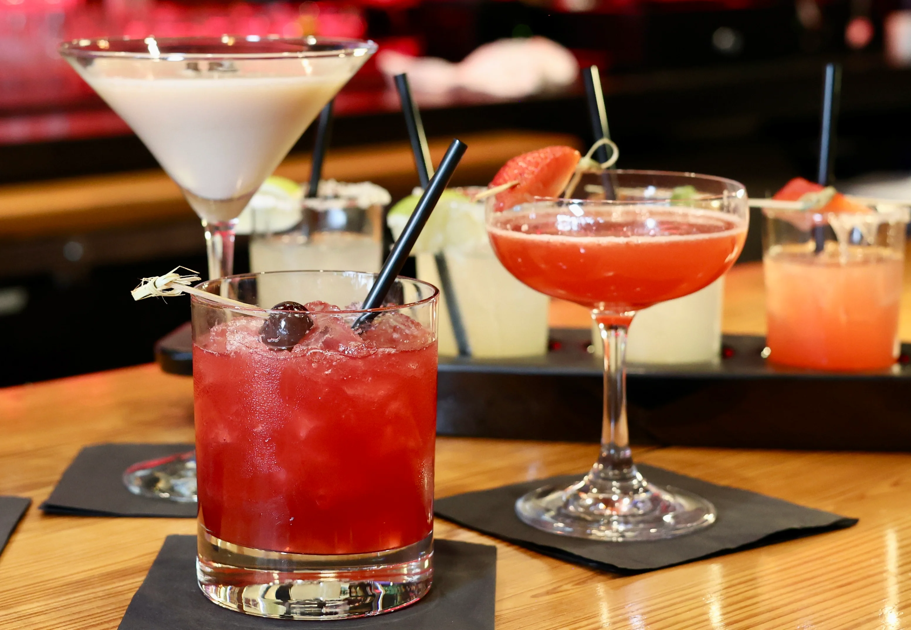 Colorful cocktails displayed on a bar counter