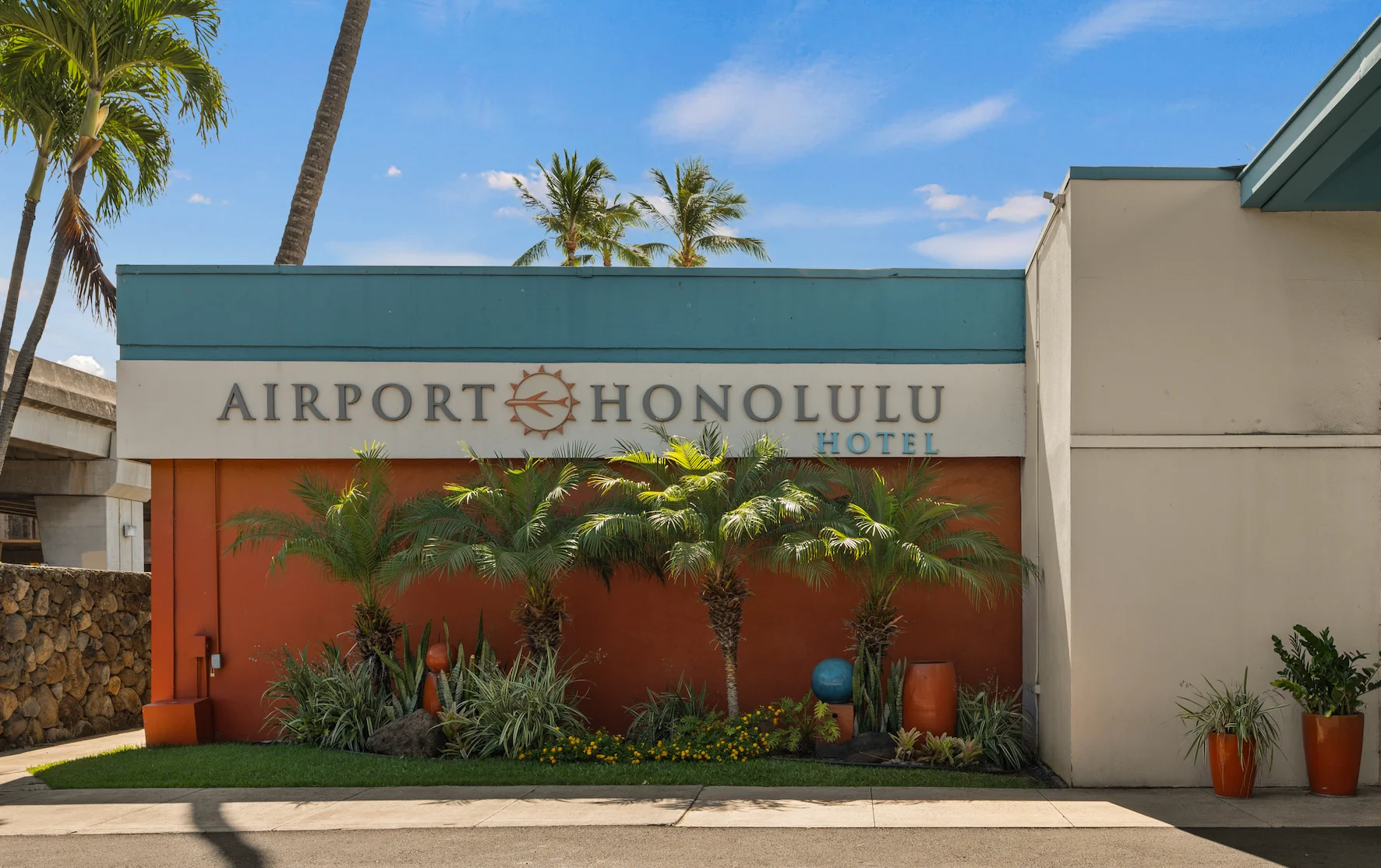 Entrance of Airport Honolulu Hotel with tropical plants