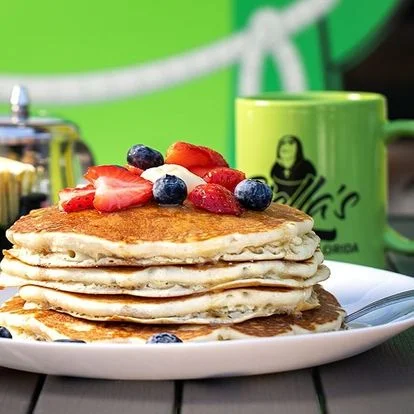 Fluffy American pancakes topped with fresh berries and whipped cream