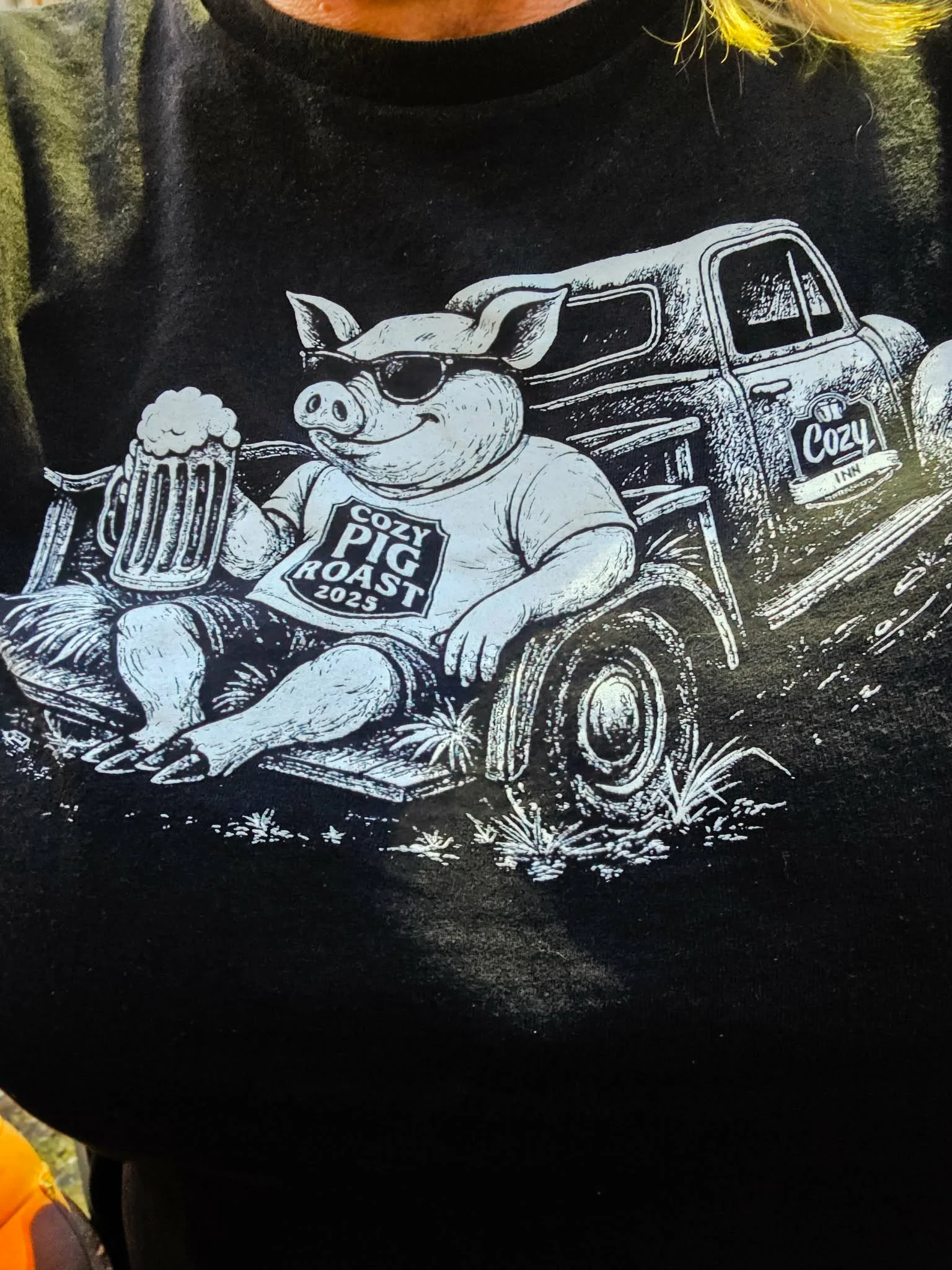 Graphic t-shirt featuring a pig with sunglasses and beer for a pig roast event