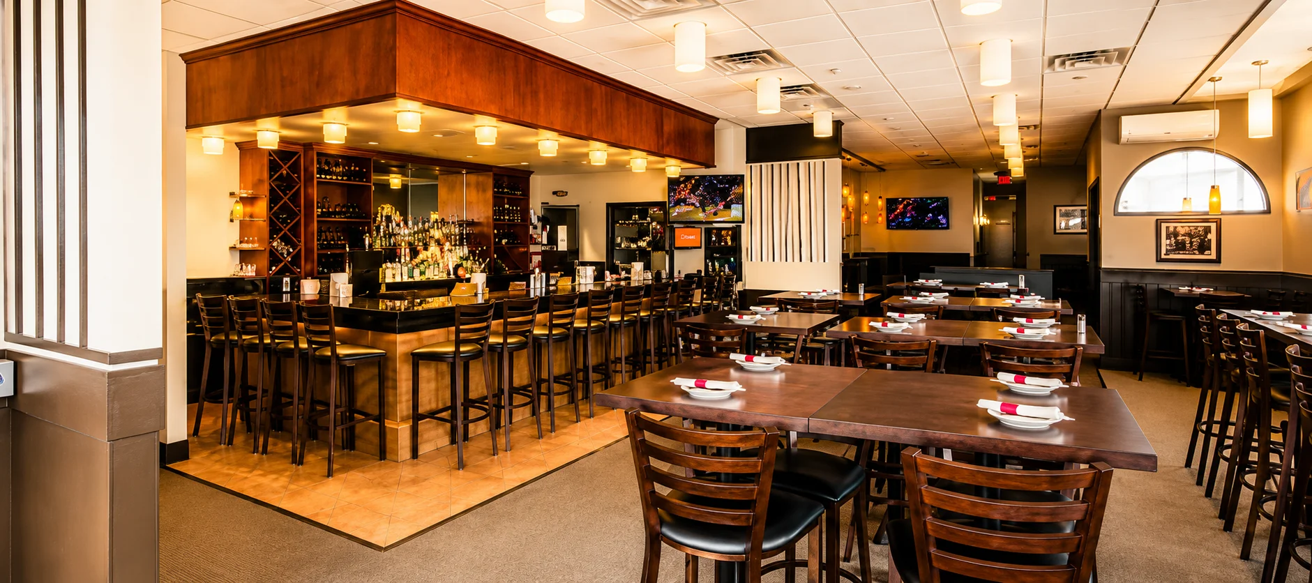 Modern restaurant interior with bar seating and warm lighting