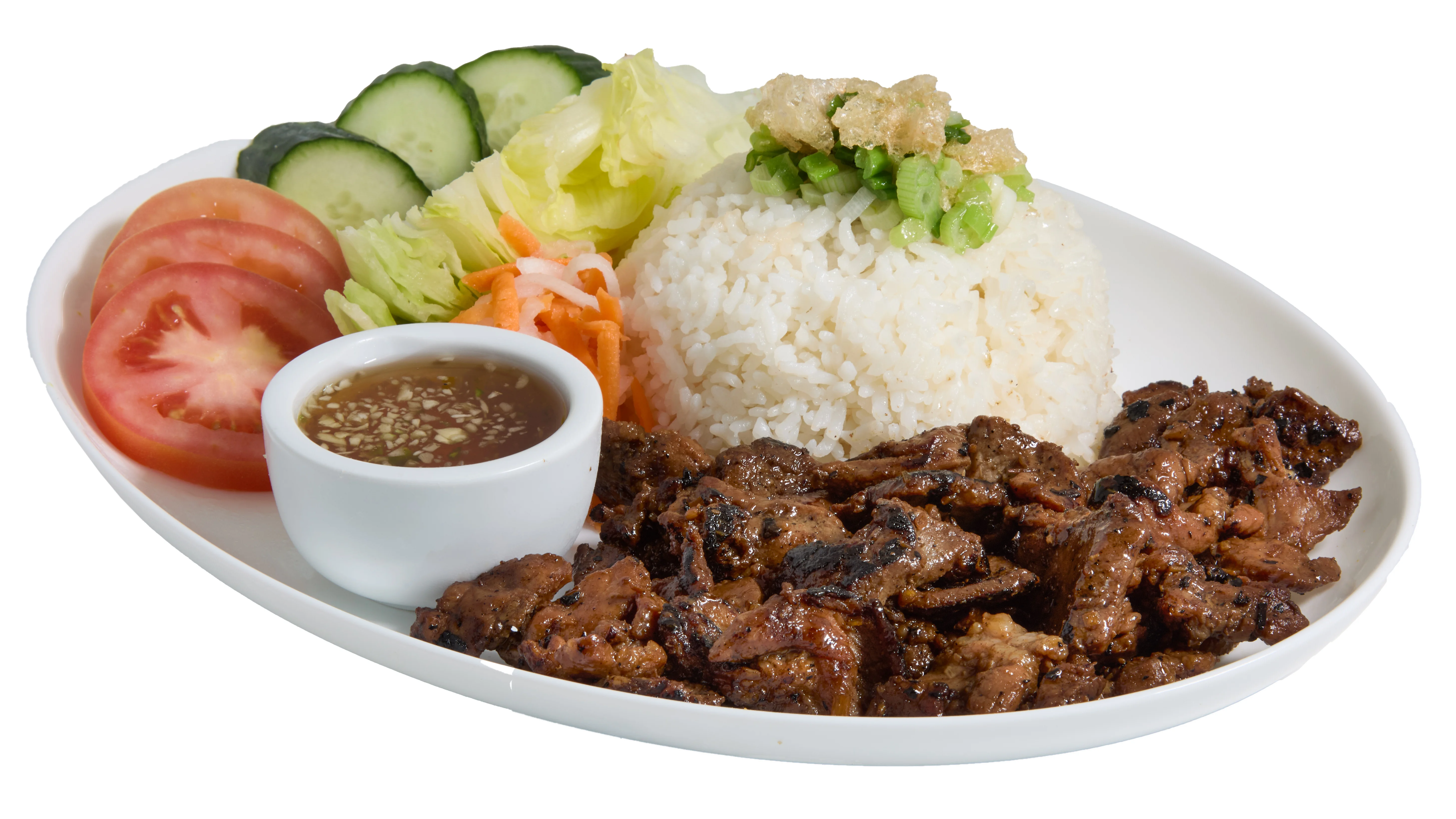 Grilled pork dish served with vegetables and garnishes on a plate.