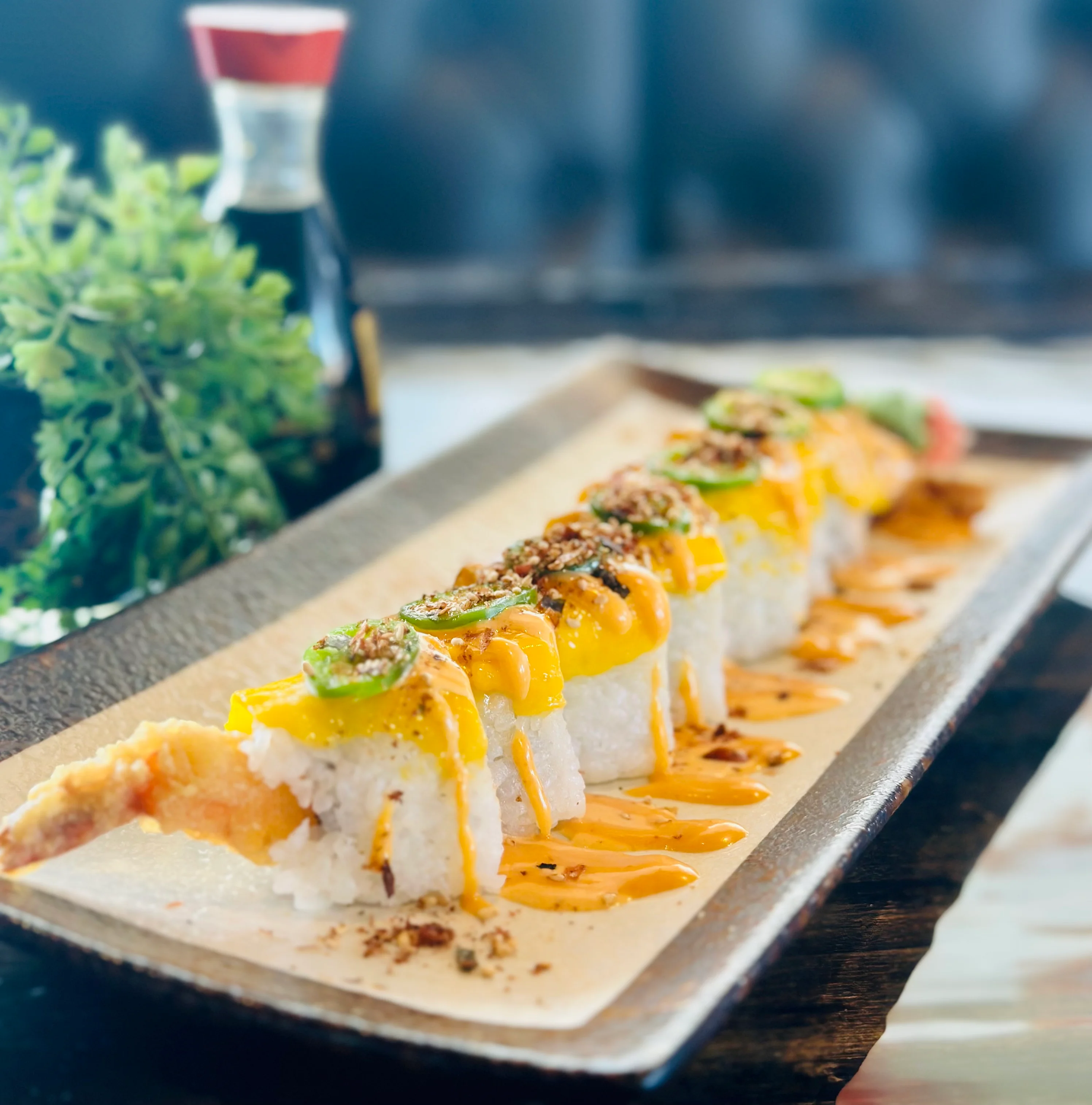 Colorful sushi roll with shrimp and spicy sauce