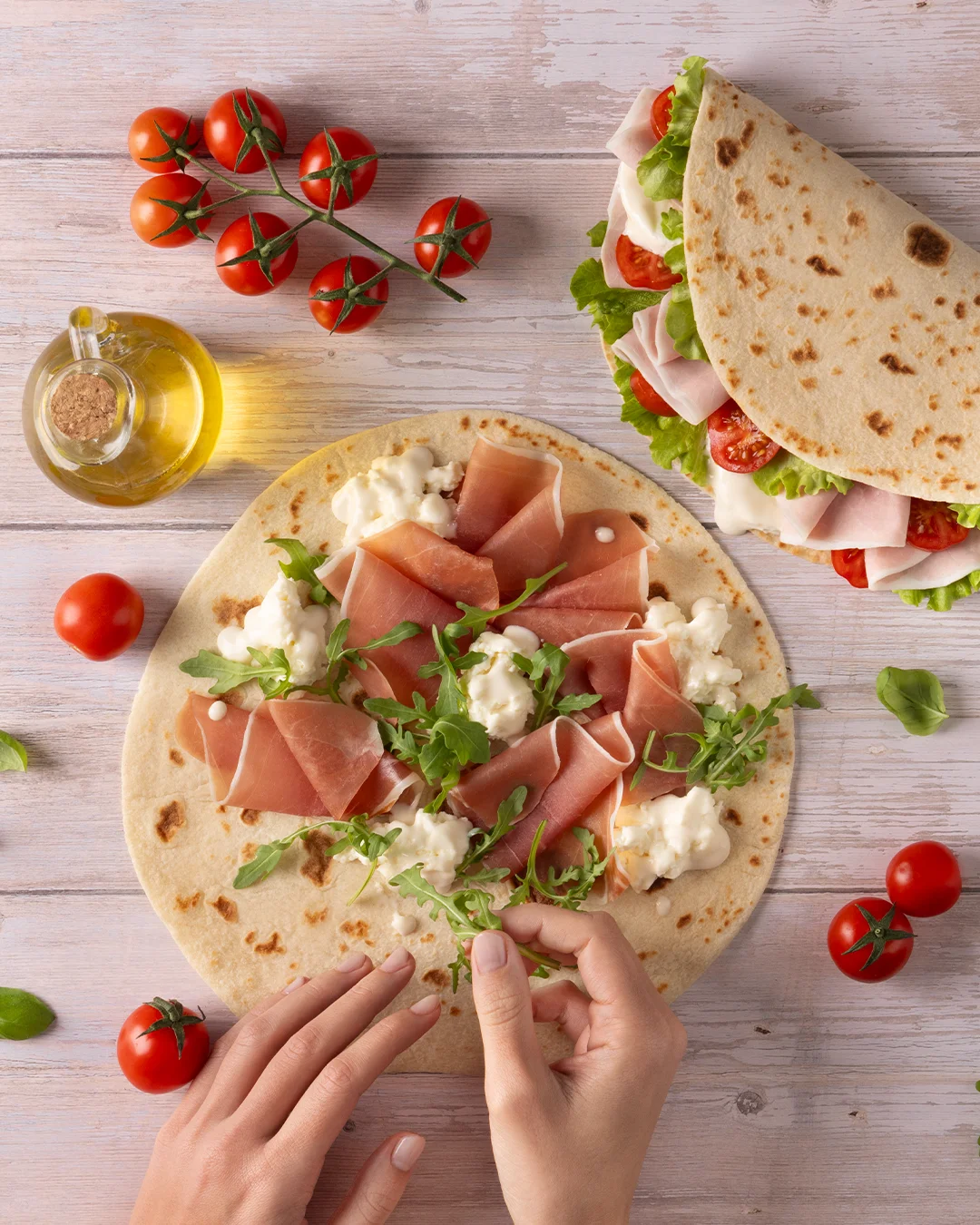 Italian prosciutto wrap with fresh greens and tomatoes