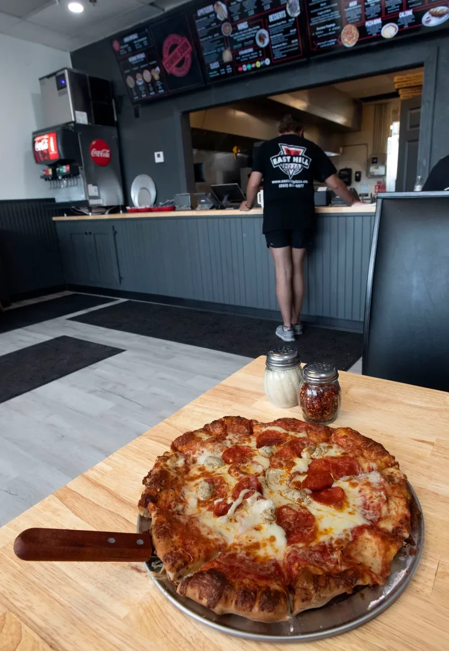 Pepperoni pizza served in a casual restaurant dining area
