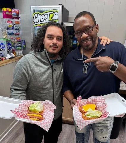 Two guys showing food