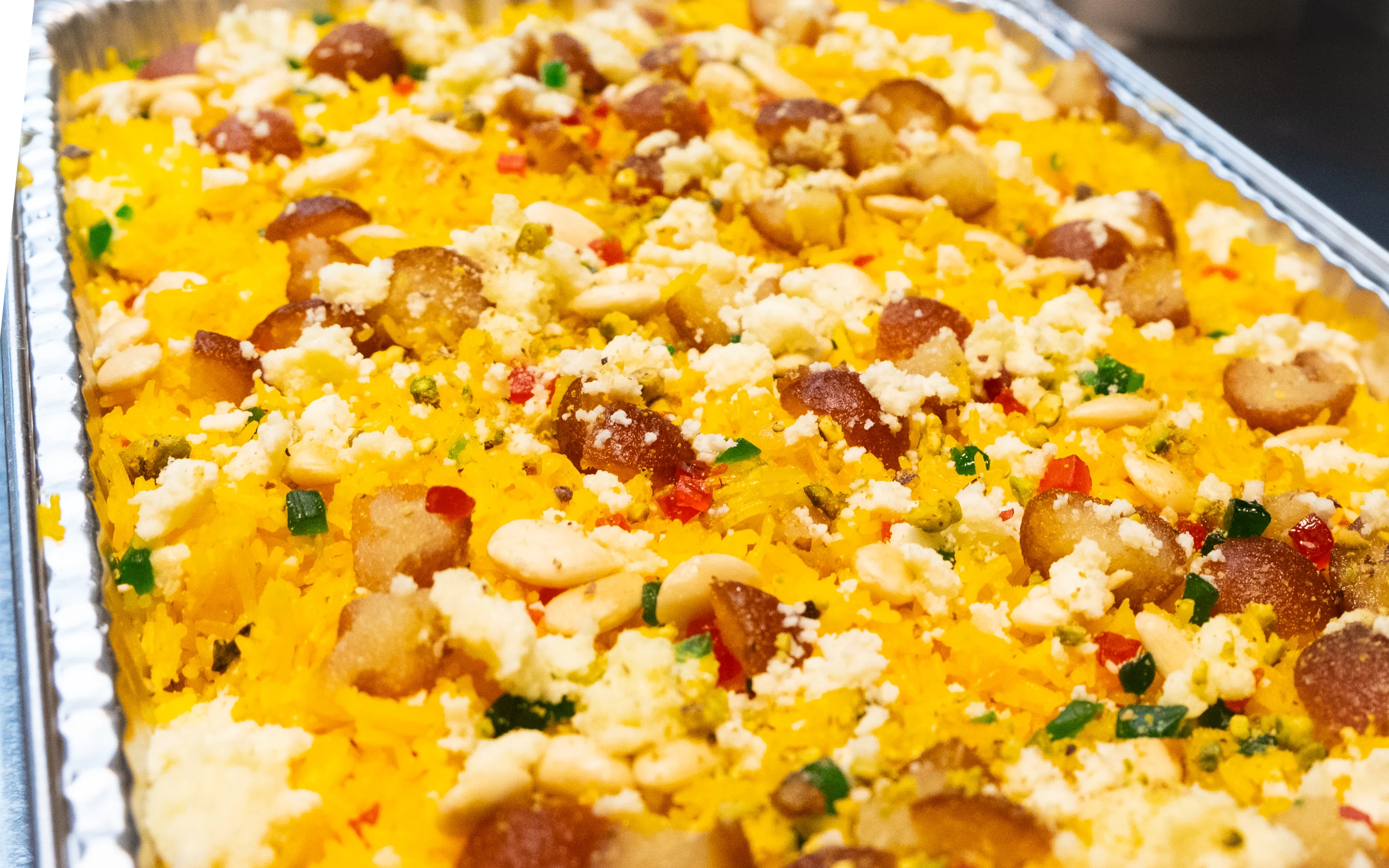 Vibrant Indian biryani topped with nuts and spices