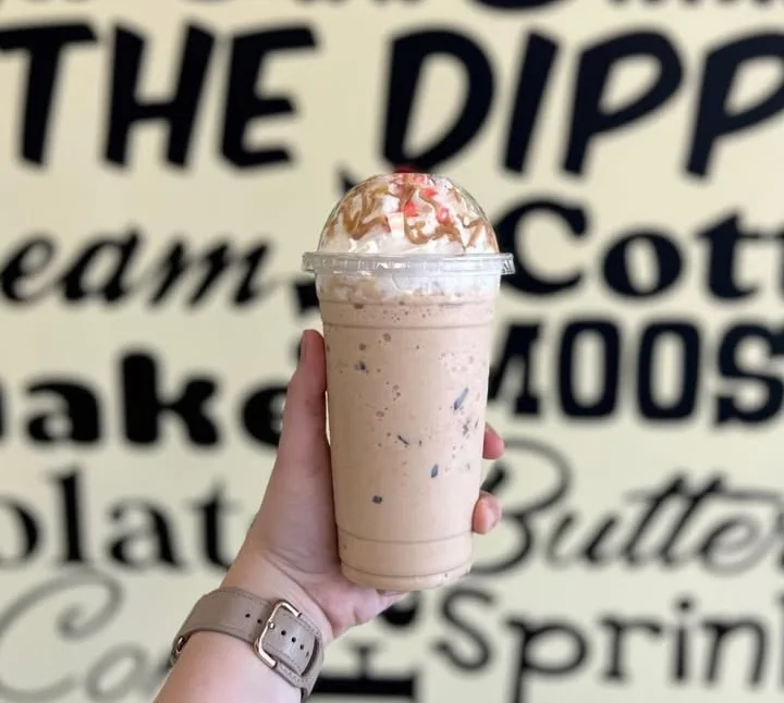 Iced caramel coffee drink topped with whipped cream