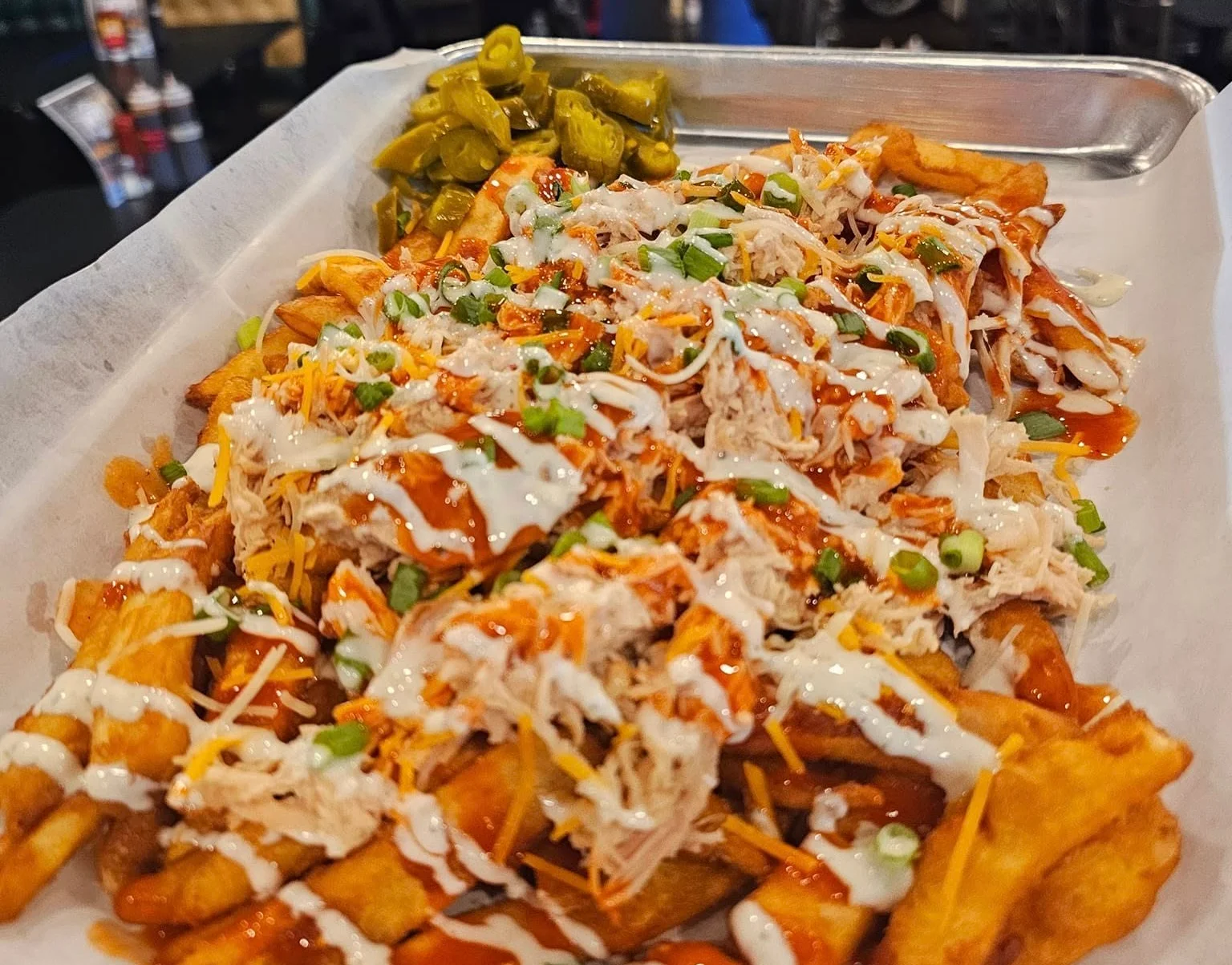 Loaded nachos with pulled chicken and toppings