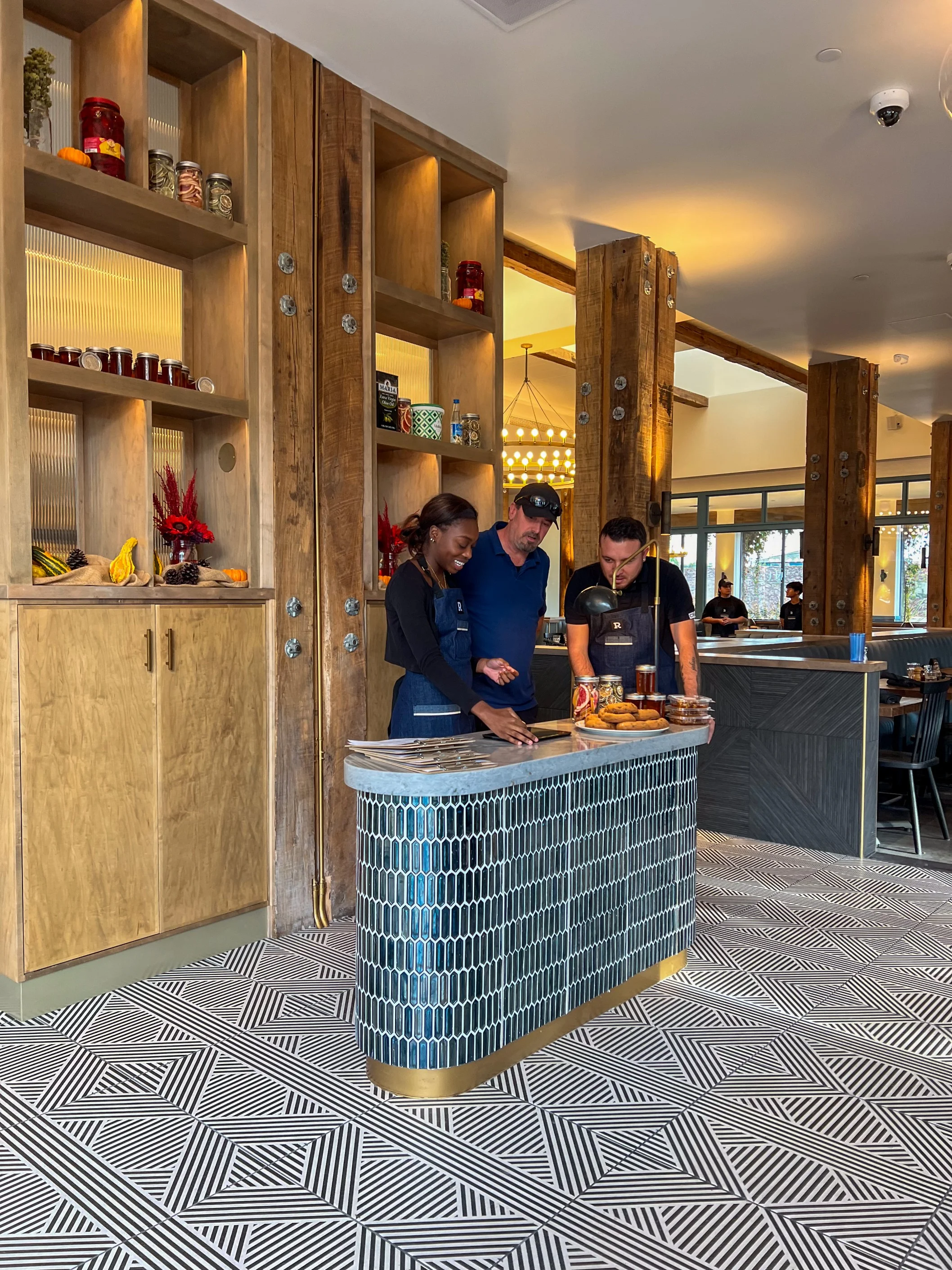 A vibrant team of restaurant staff smiling together in a welcoming environment.