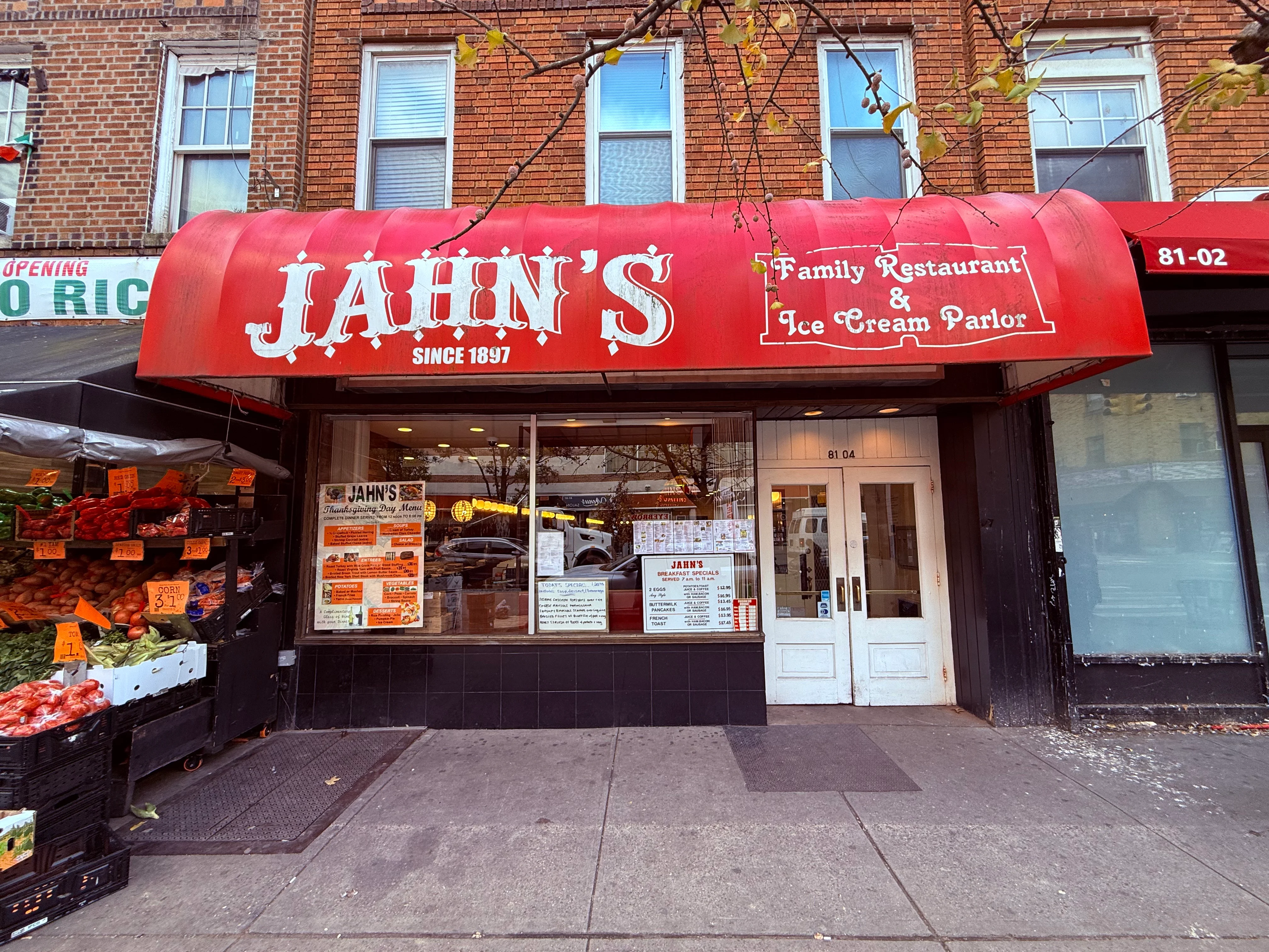 An interior view of a retro diner with red booths, a long counter with high stools, and vintage decorations.