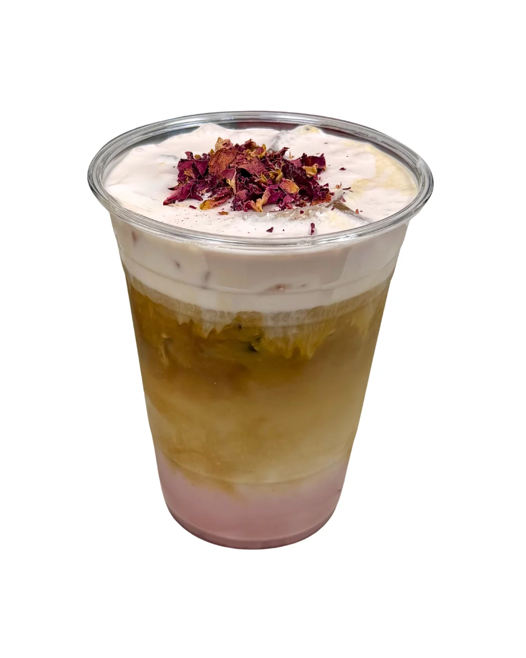 A layered beverage in a clear cup featuring a mix of cream, yellow, and pink layers topped with dried rose petals.