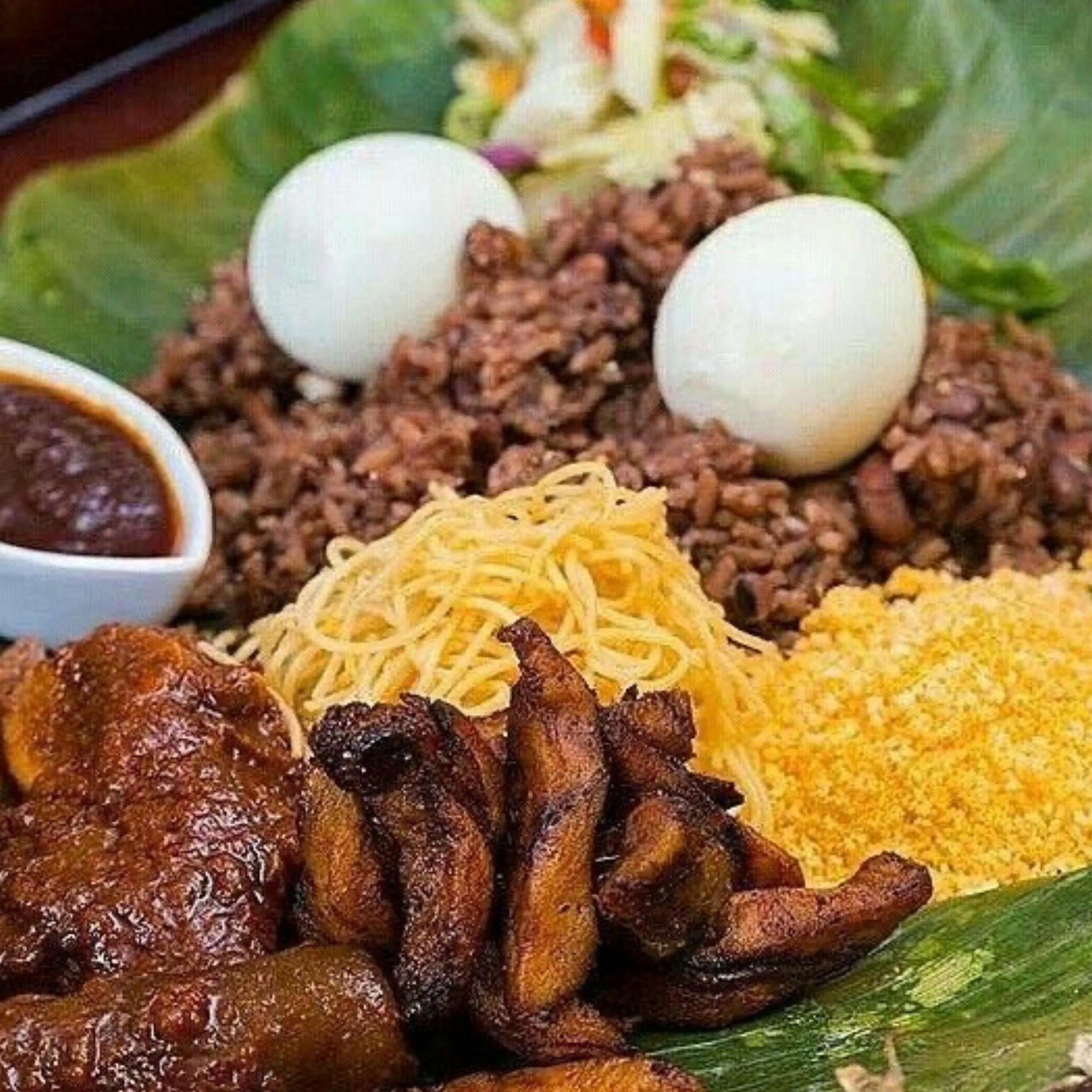 Nigerian jollof rice platter with assorted sides