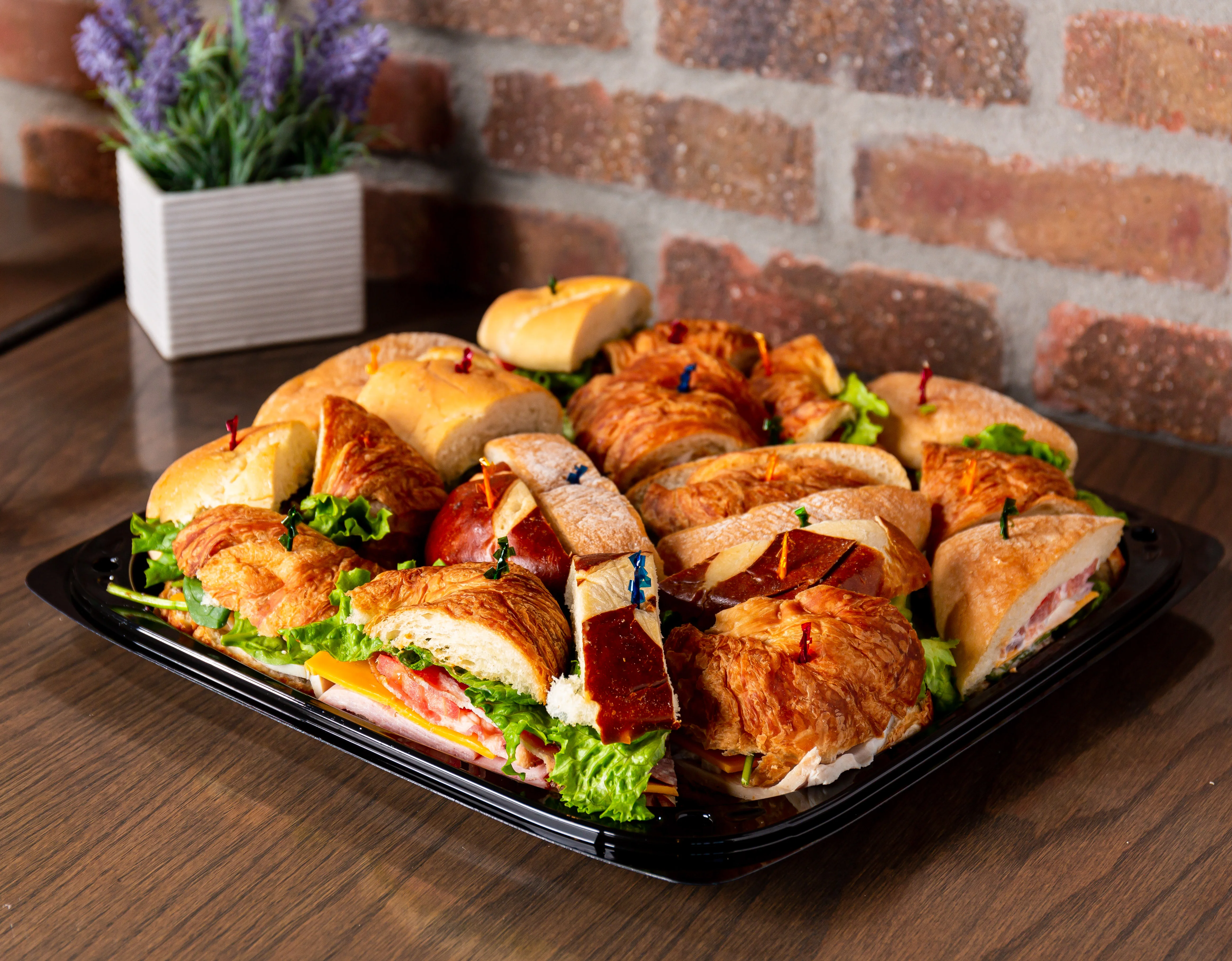 Assorted sandwich platter with croissants and fresh greens