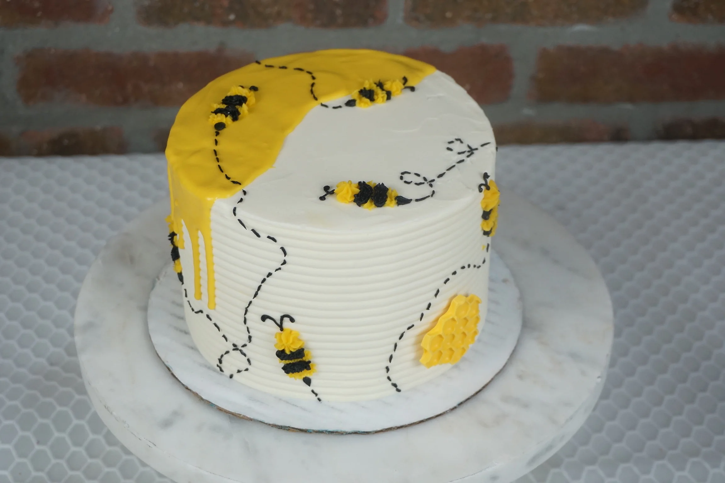 Bee-themed cake with yellow and black decorations