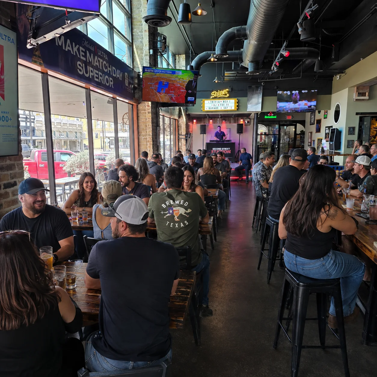 Lively restaurant interior with patrons enjoying drinks and live music