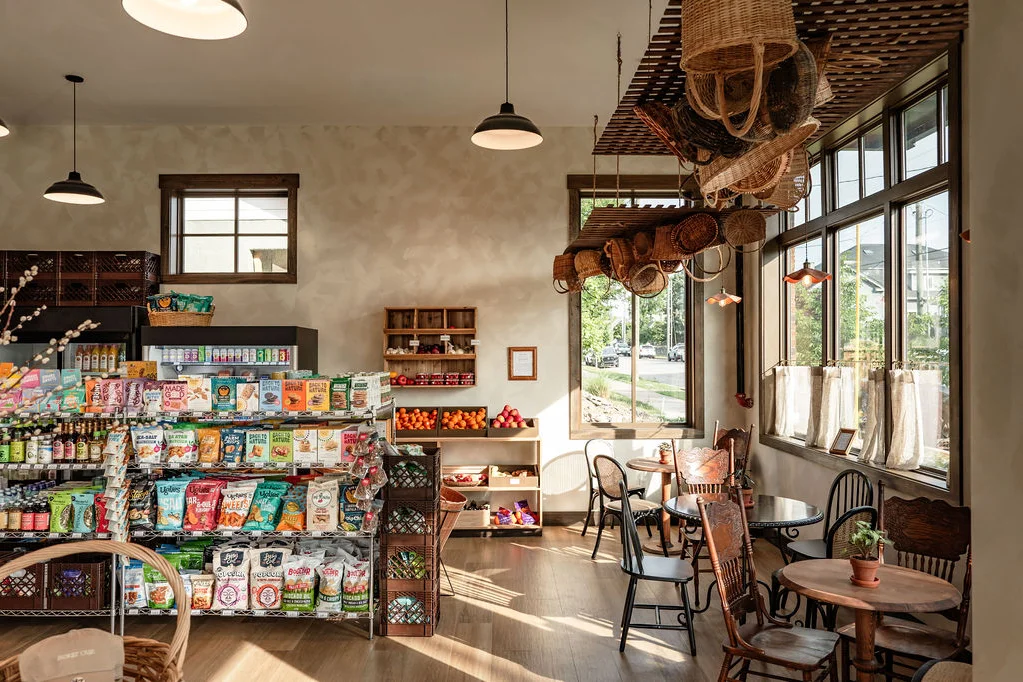 A beautiful shot of the seating area in the cafe and stocked grocery shelves