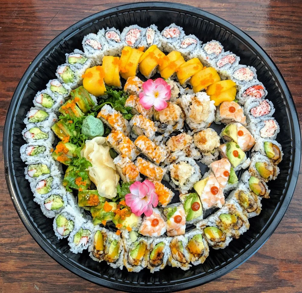 Assorted Japanese sushi platter with colorful rolls and garnishes