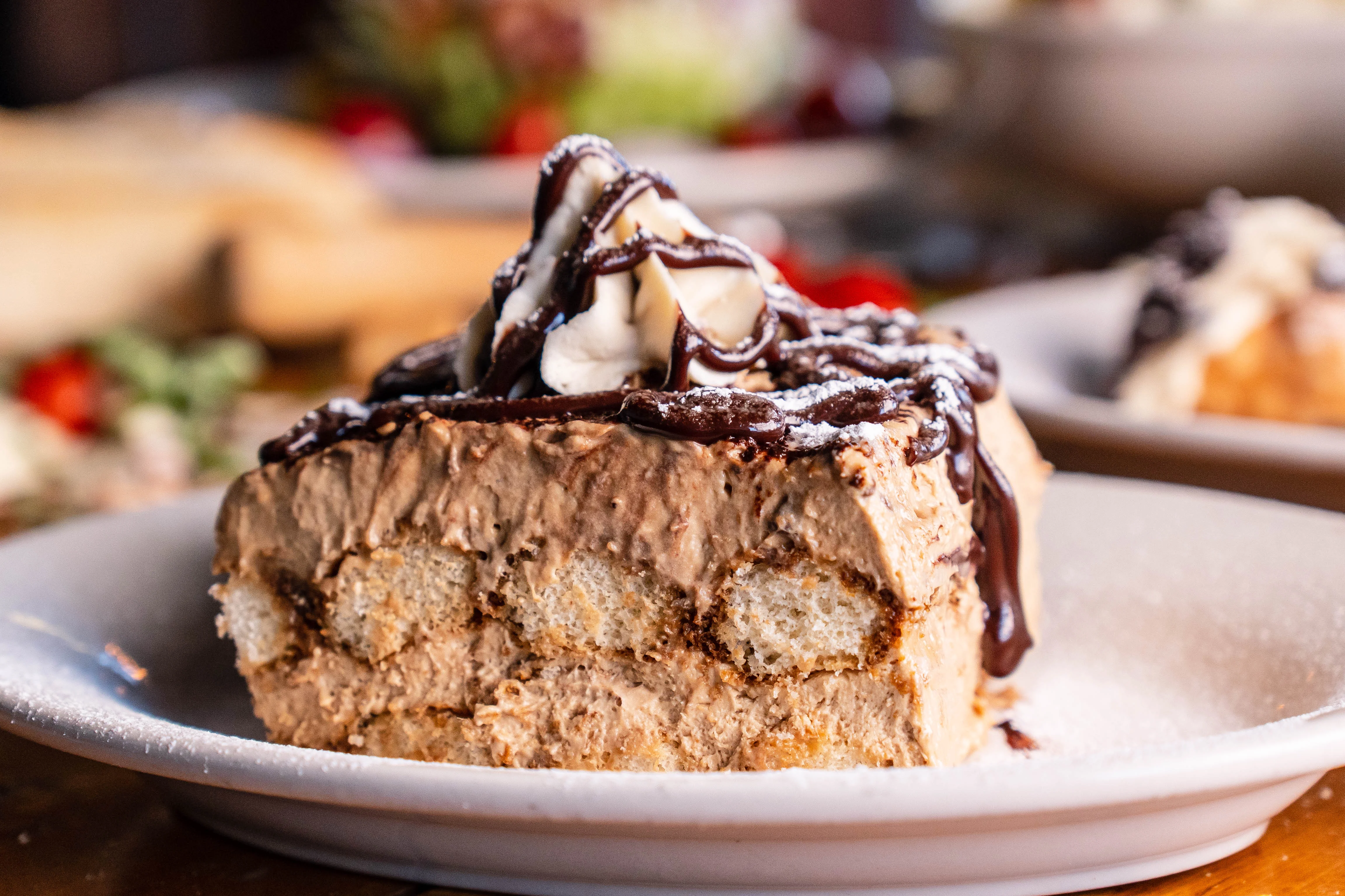 Decadent chocolate mousse cake slice with whipped cream