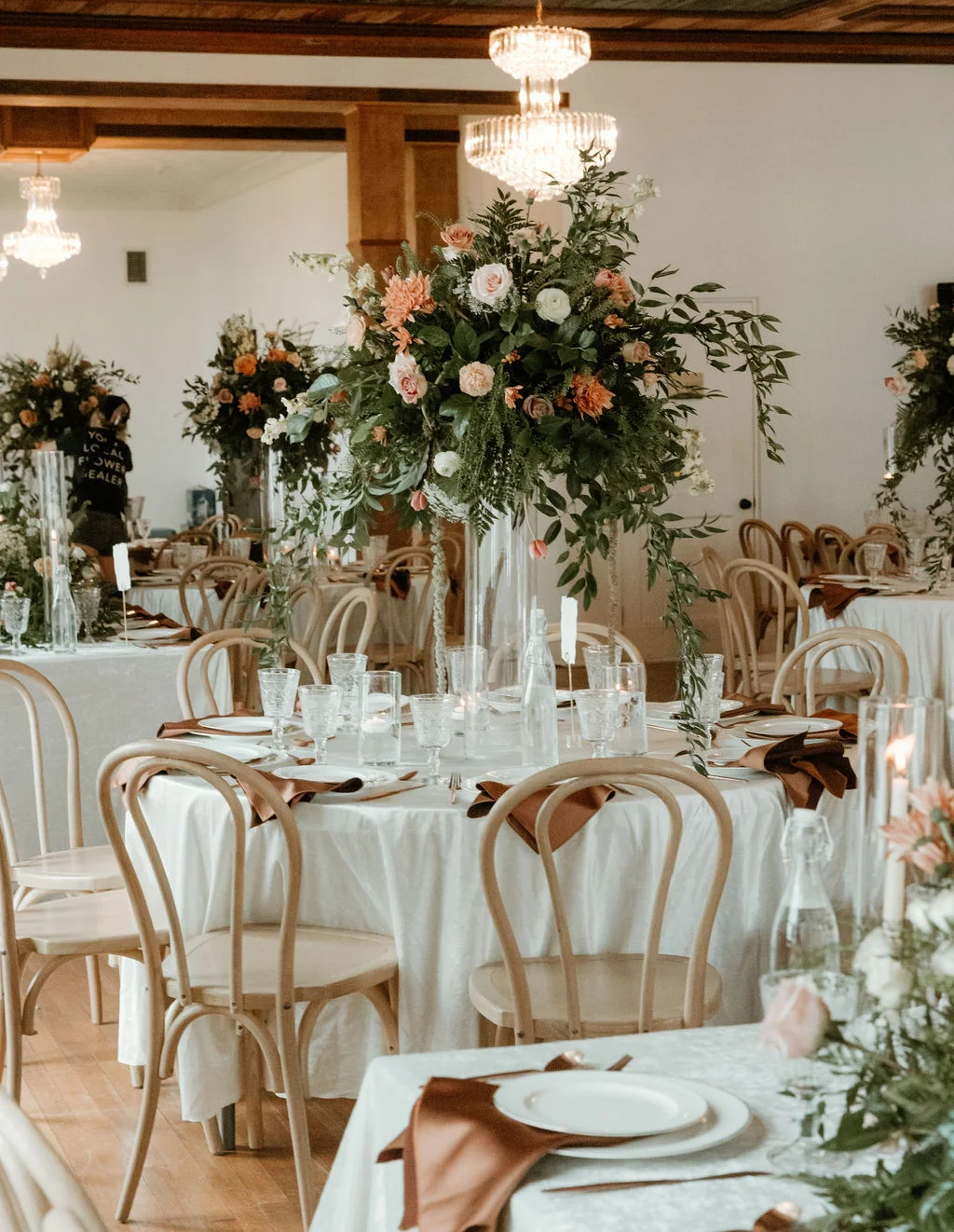 Elegant dining setup with floral centerpieces and warm lighting