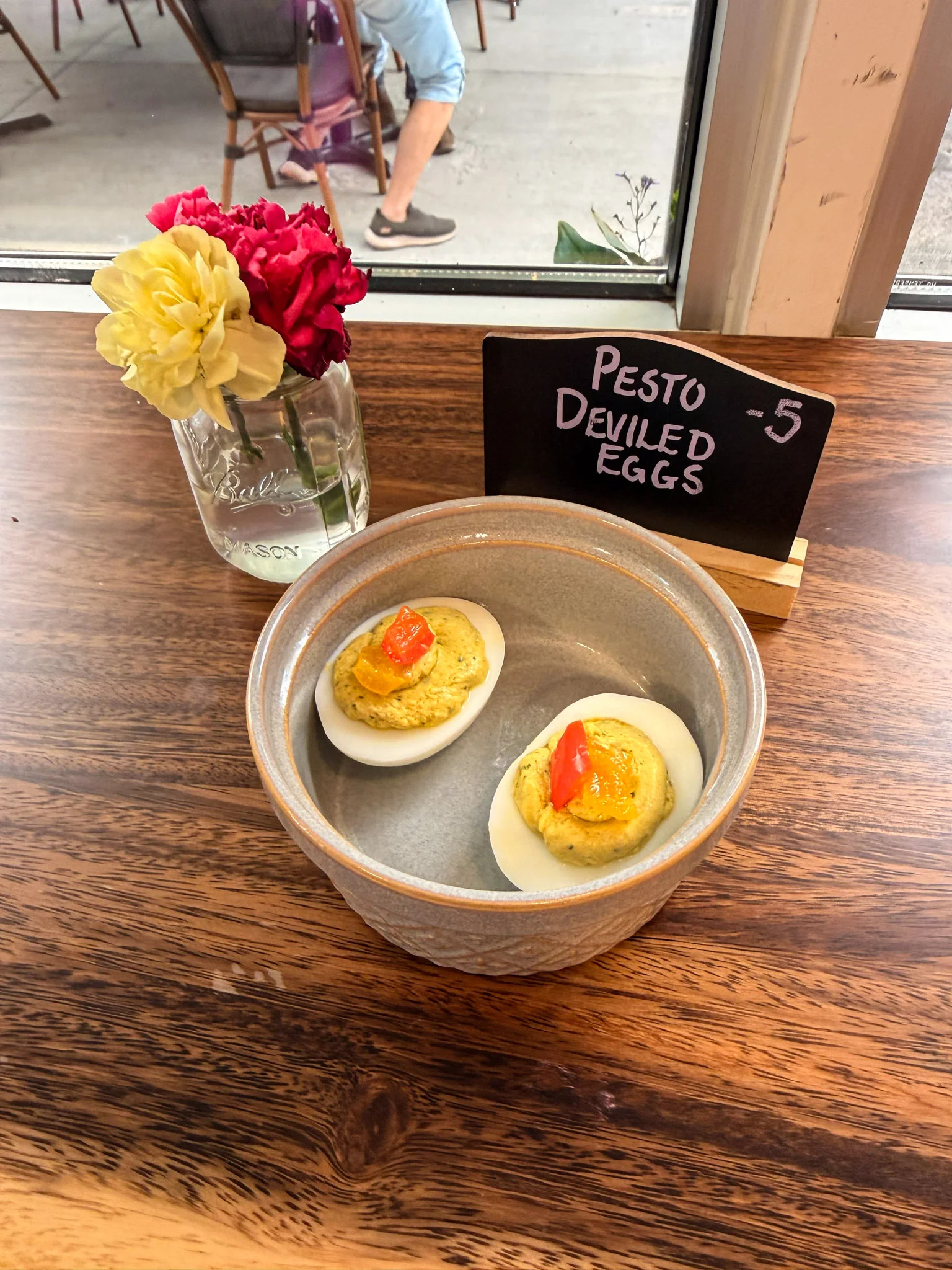 Pesto deviled eggs served in a rustic bowl