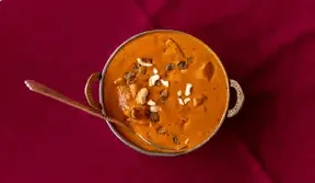 Shahi paneer masala in a traditional bronze serving bowl.
