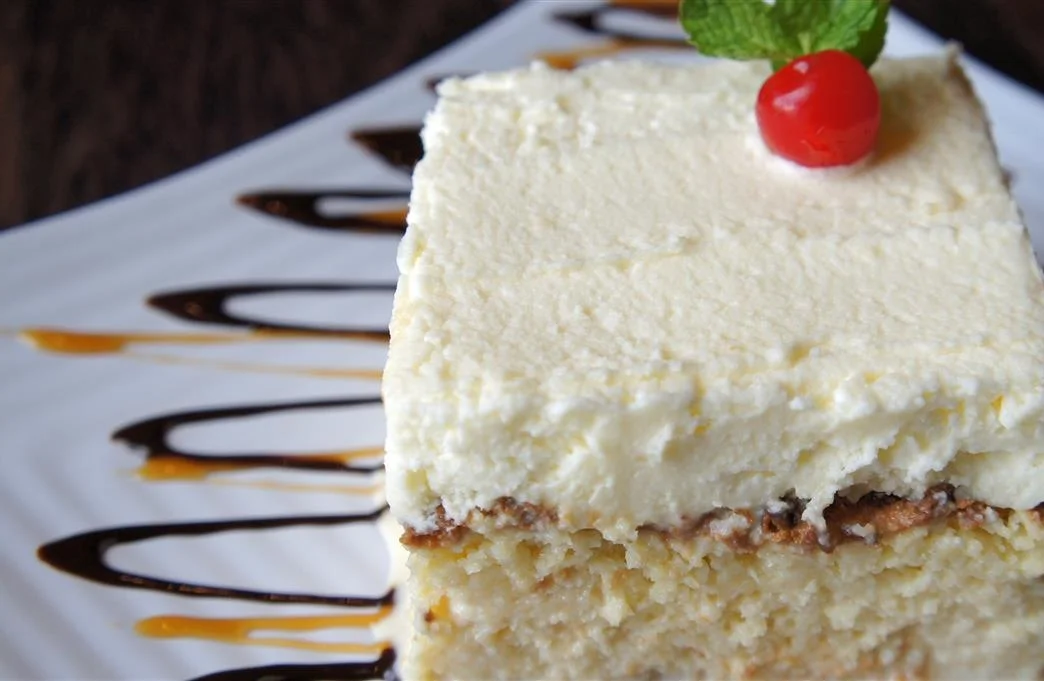 Delicious slice of Italian tiramisu with cocoa and cherry garnish