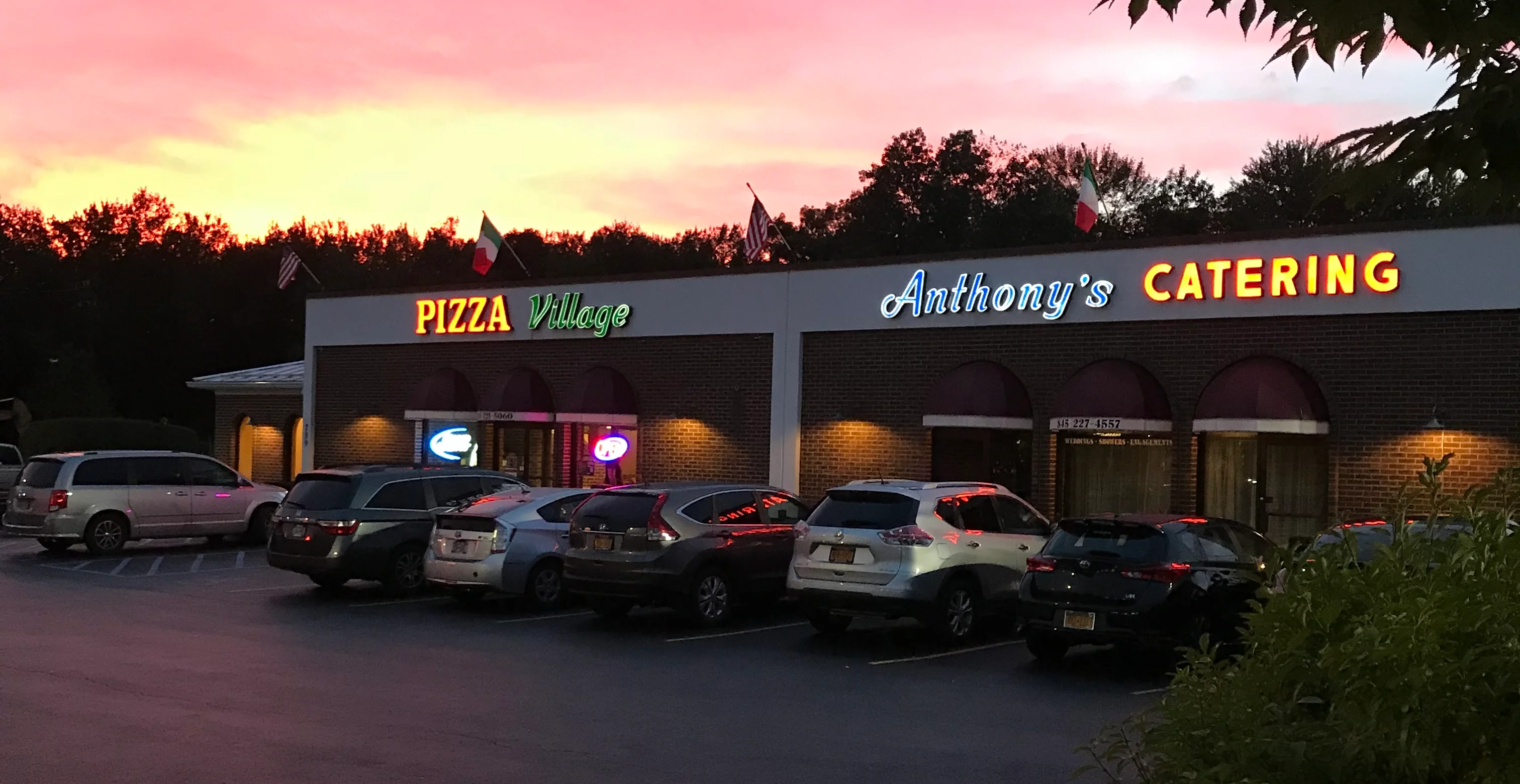 Pizza Village restaurant exterior at sunset
