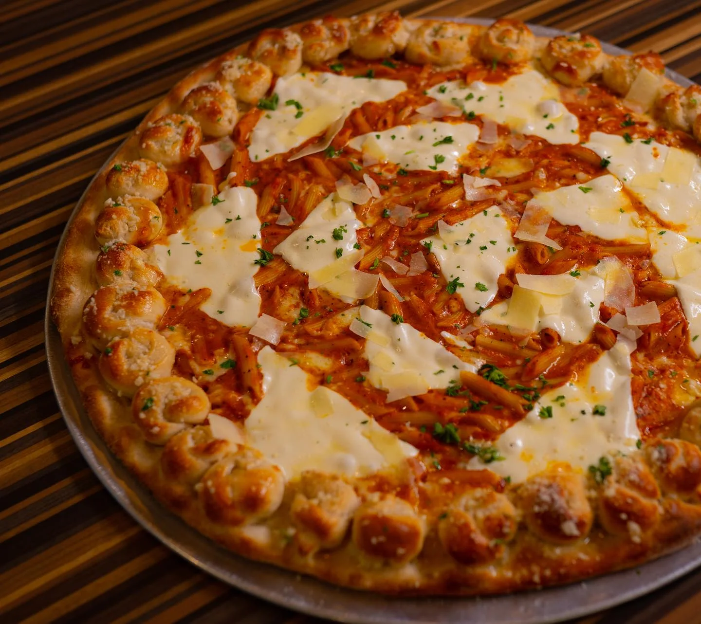 Pasta pizza with creamy sauce and cheese