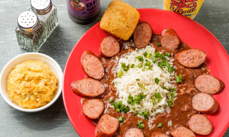 Red beans and rice from VooDoo BBQ in Pensacola, served with Andouille sausage, green onions, and a piece of cornbread.