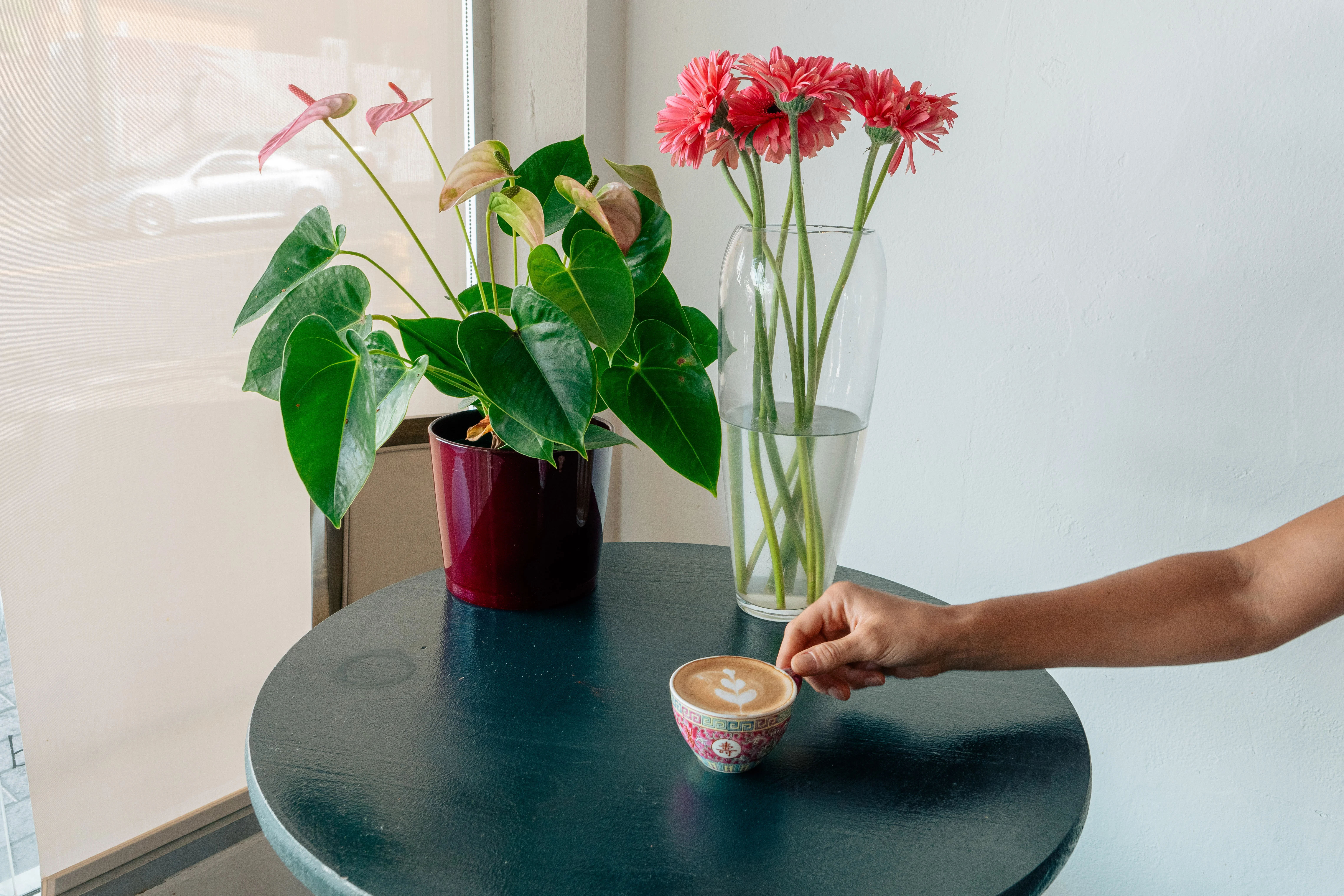 Artisan coffee served in a decorative cup on a wooden table