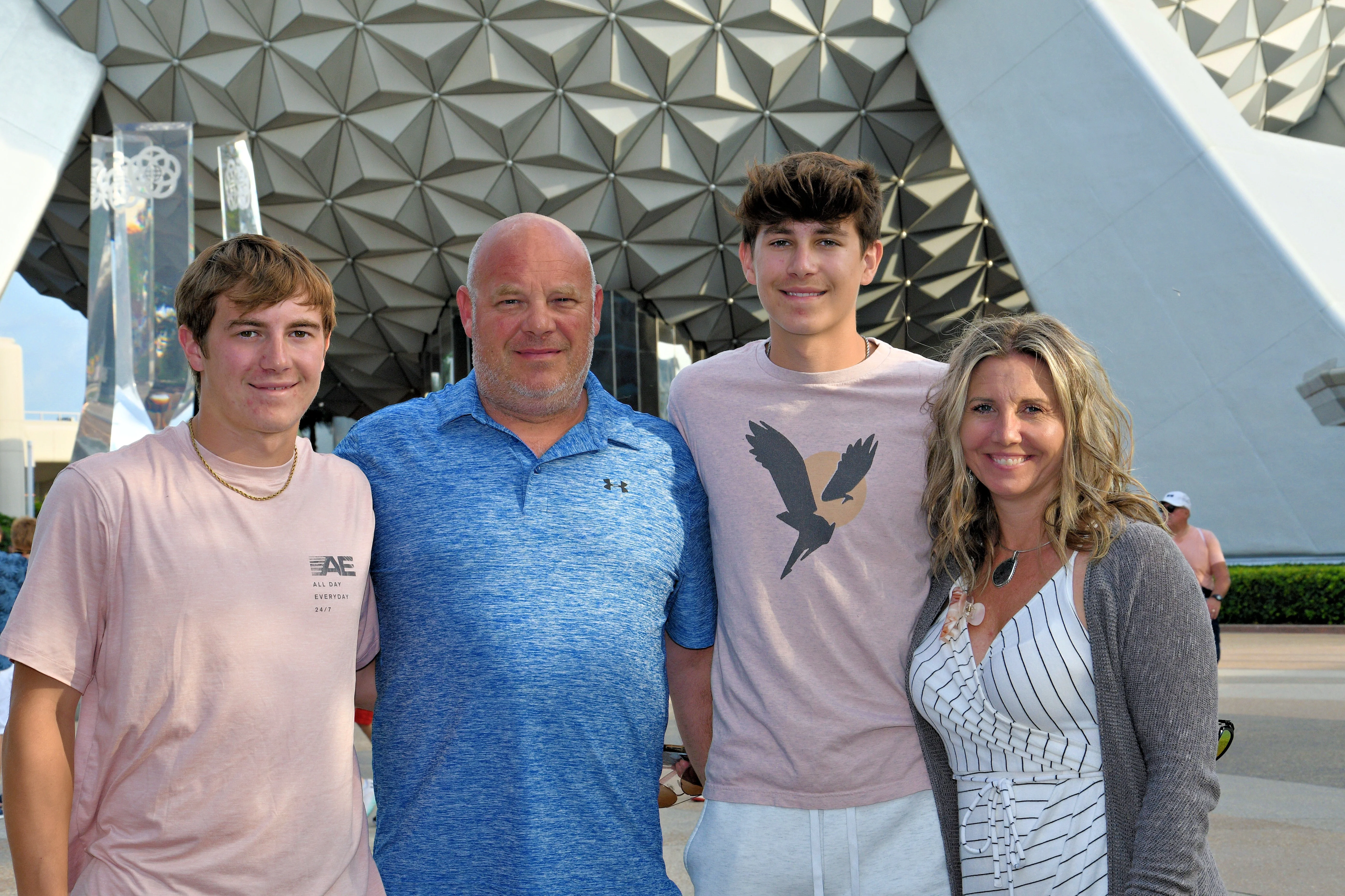Family posing in front of a modern architectural structure